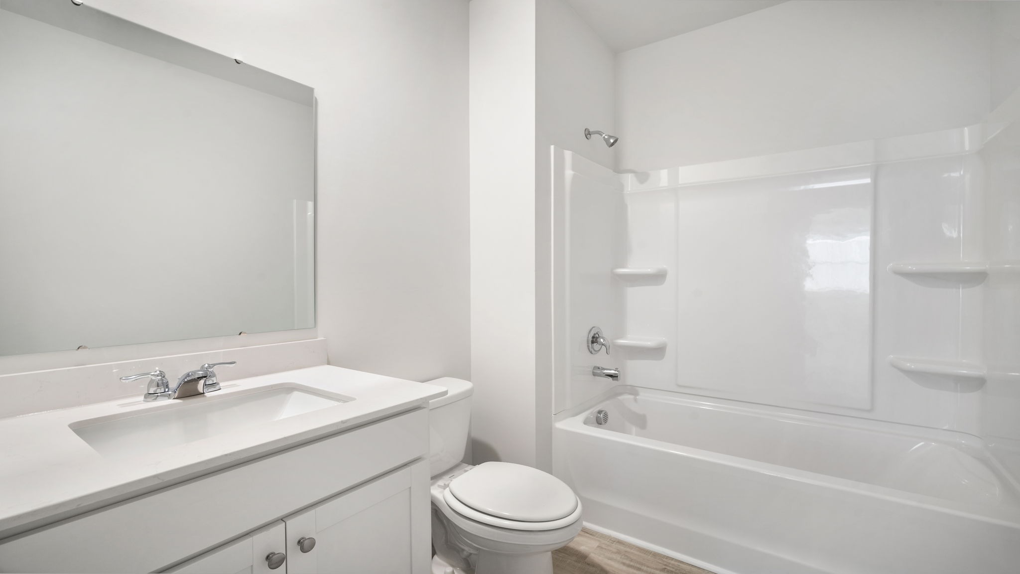 Bathroom 2 with shower tub combo and white cabinetry and quartz countertops