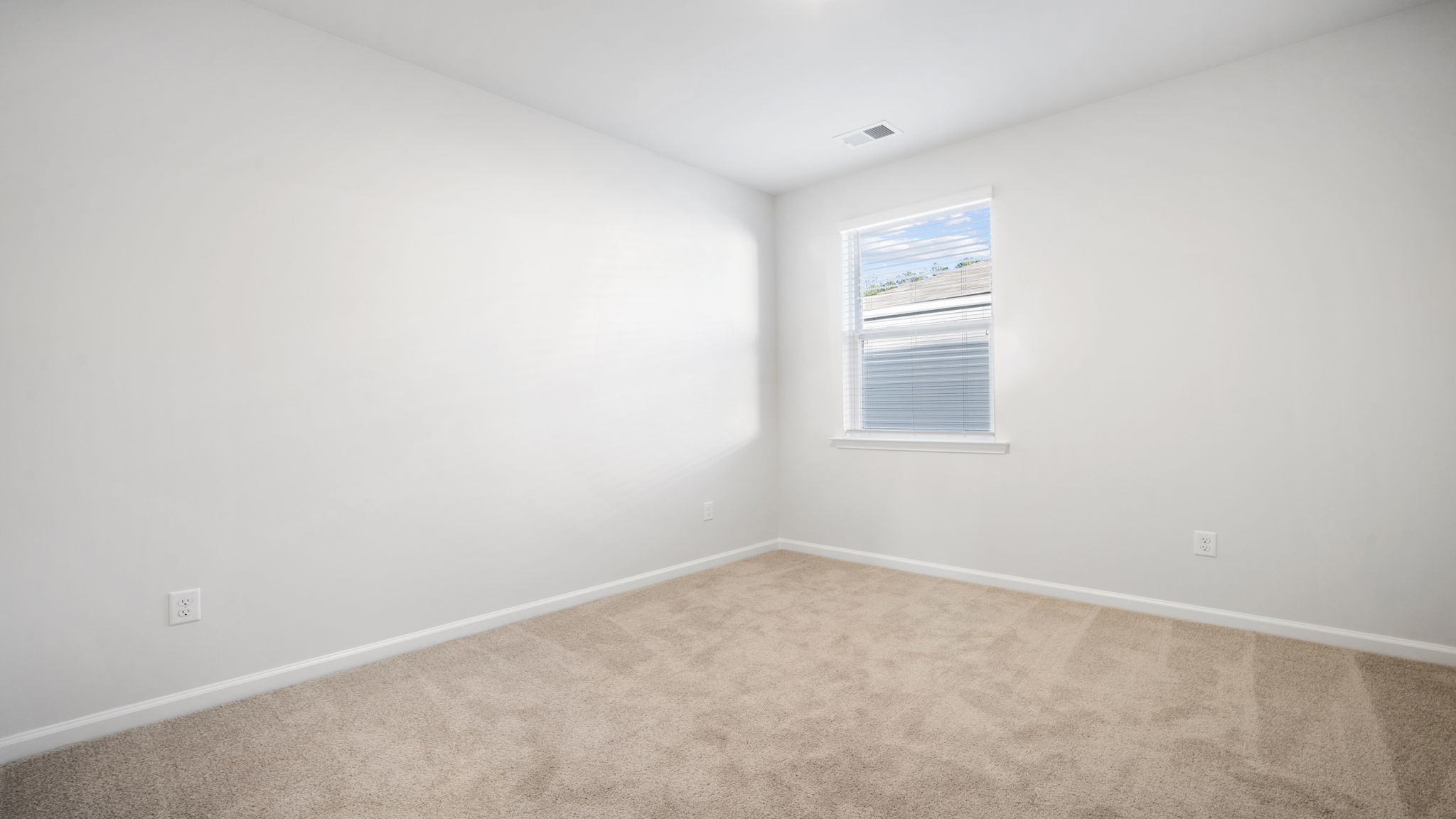 Bedroom 3 with window for light and carpet flooring