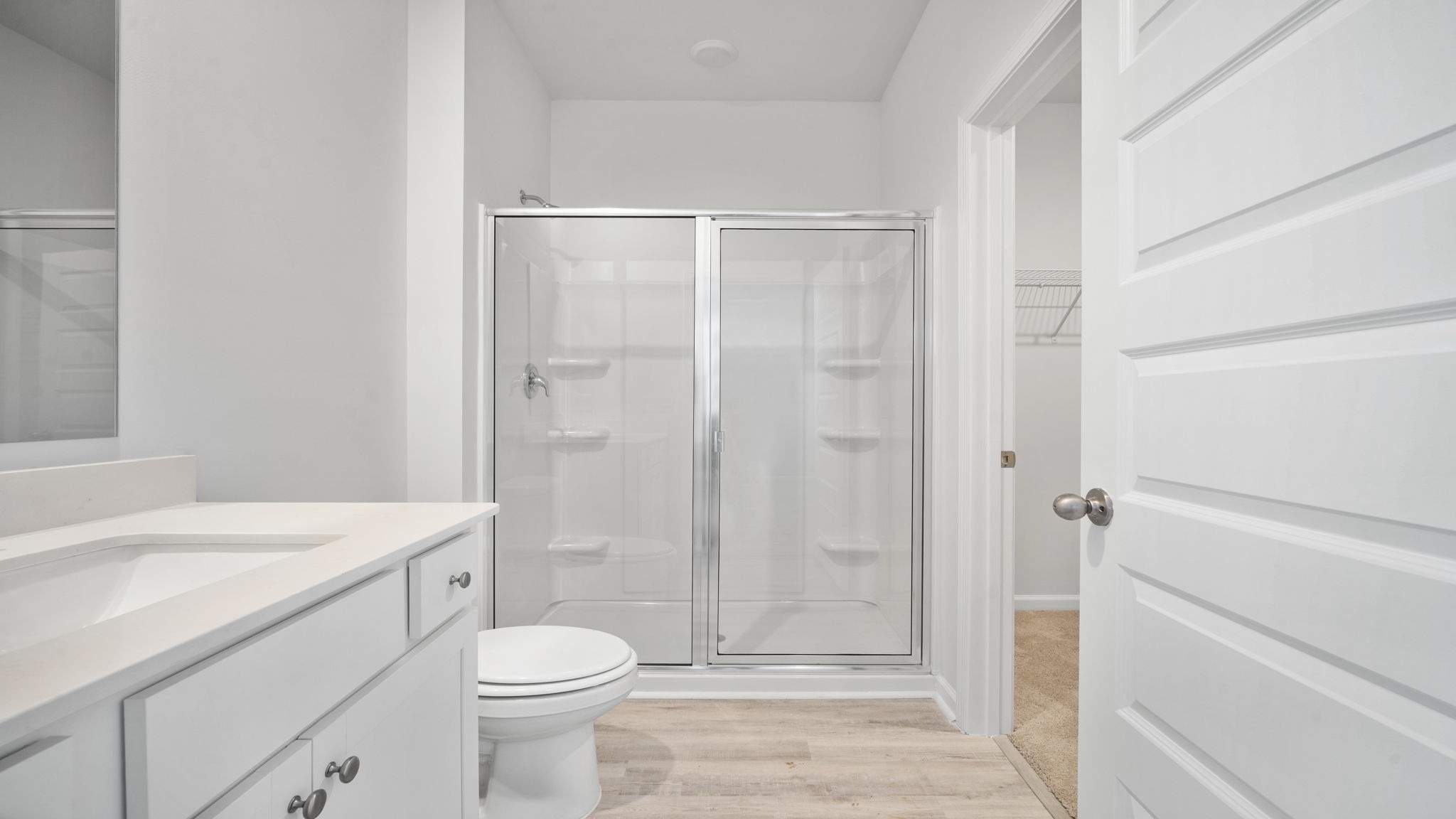 Standup primary shower with glass doors