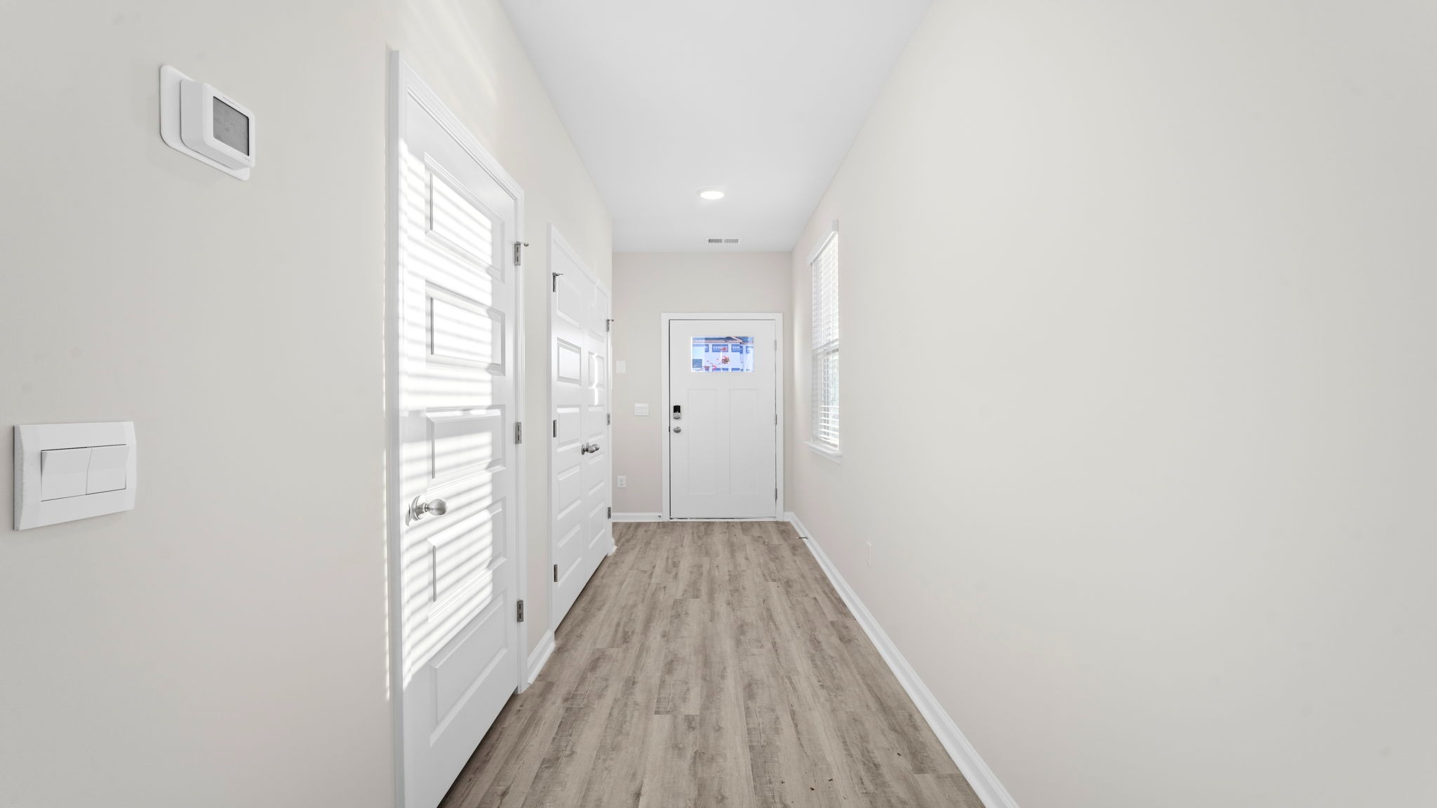 Front foyer extends from the front door into the kitchen space and open living areas