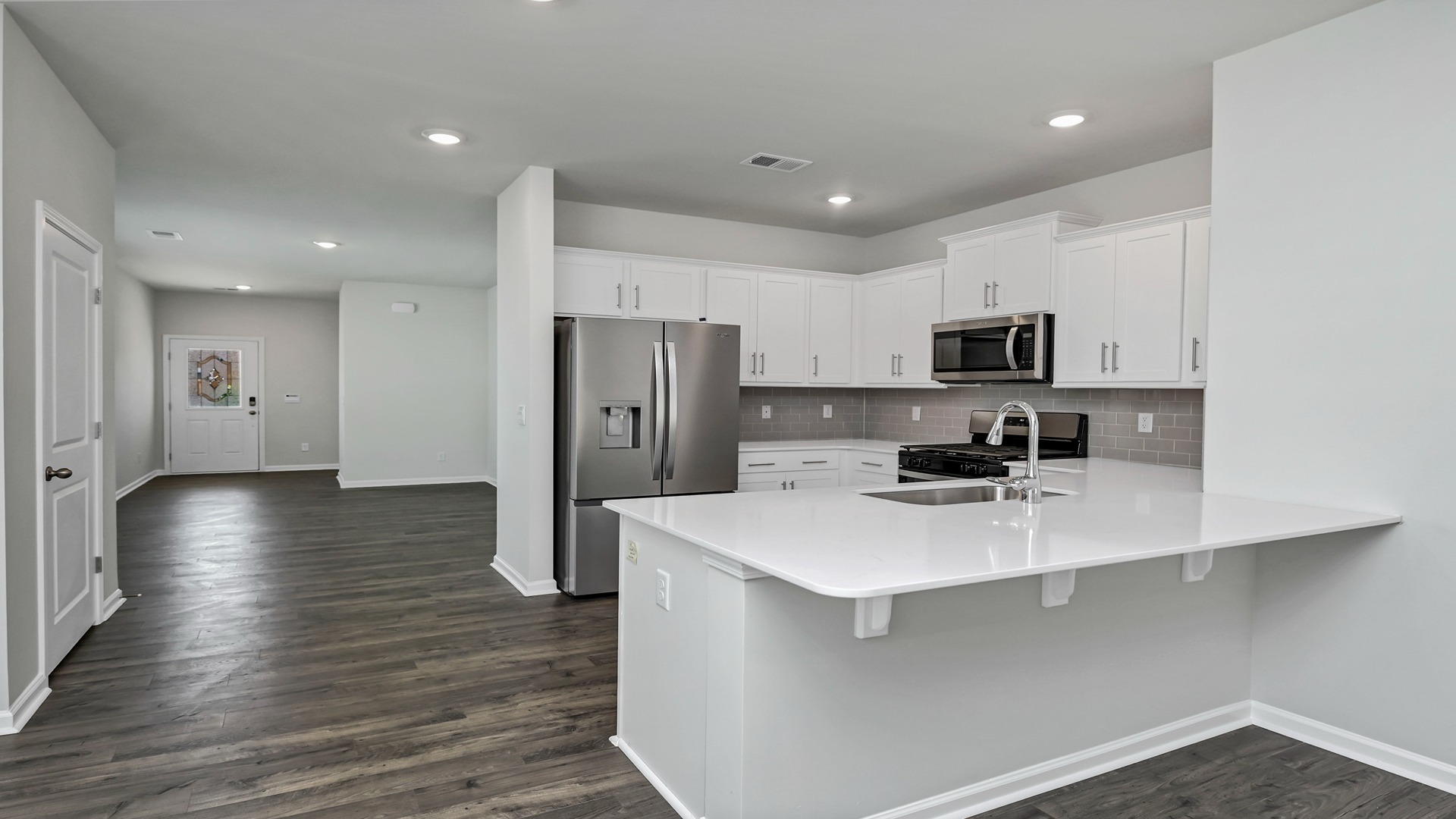 Kitchen area opens off the dining space and faces the living space