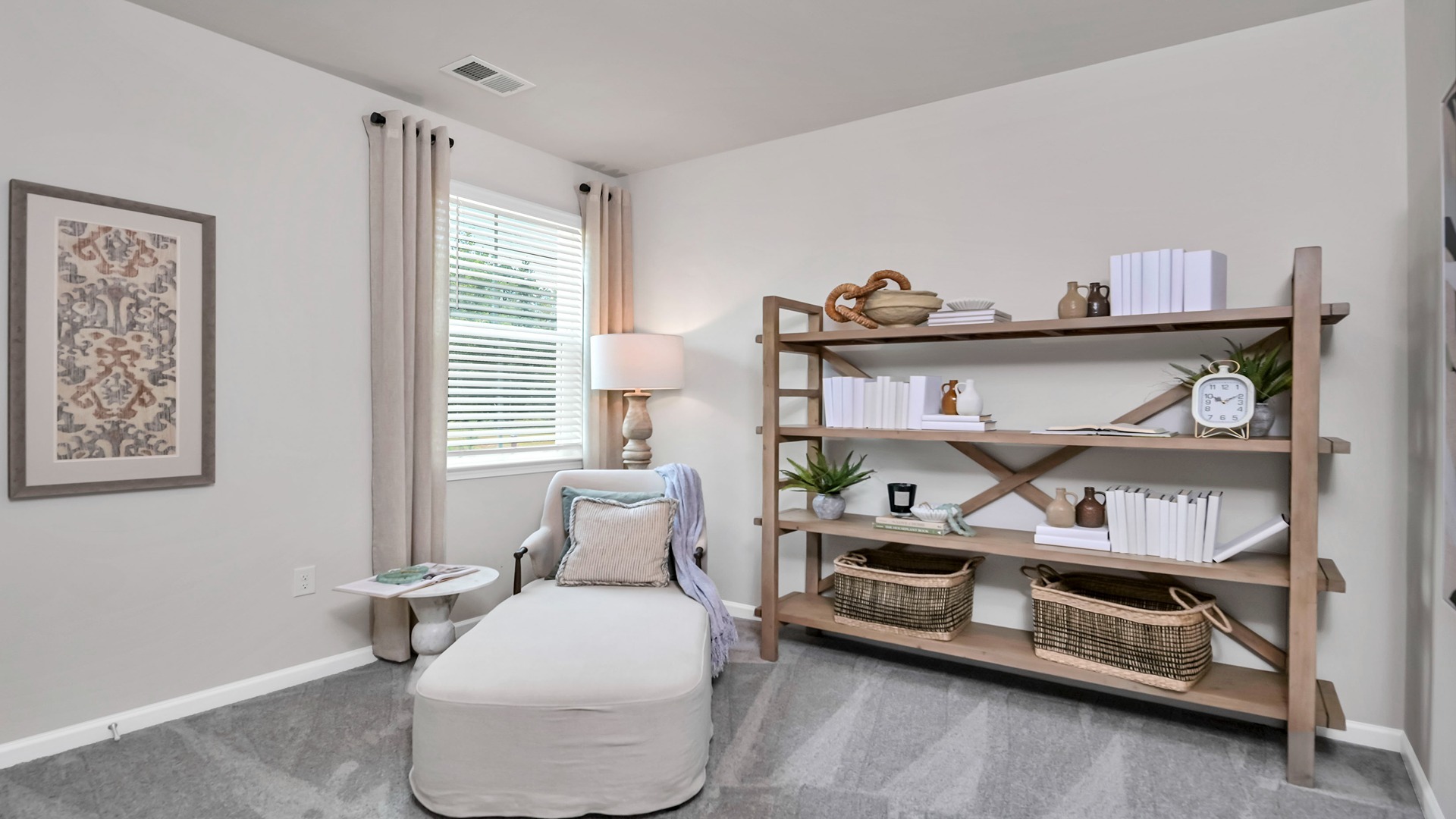 Bedroom 2 at the front of the home with a window for light and carpet flooring