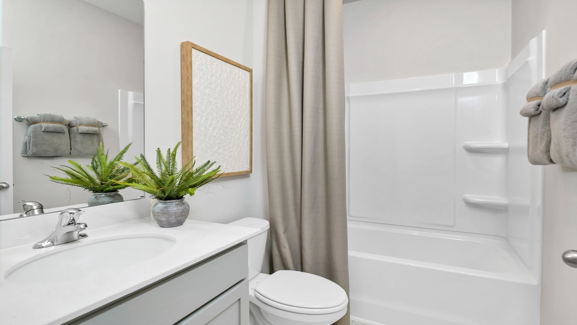 Bathroom 2 in available home with a shower tub and single-sink vanity