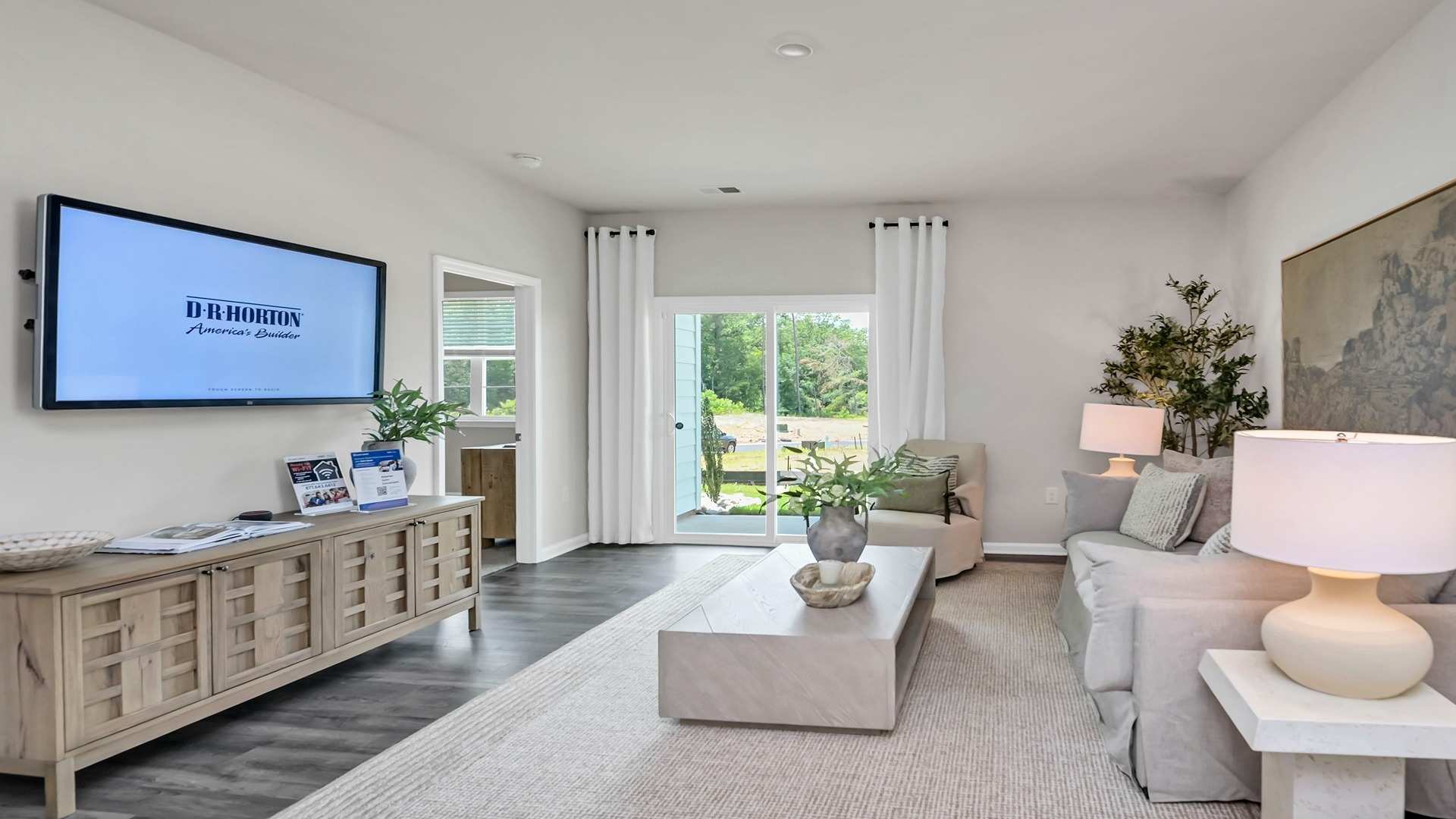 Living area in new construction home with RevWood floors and natural light