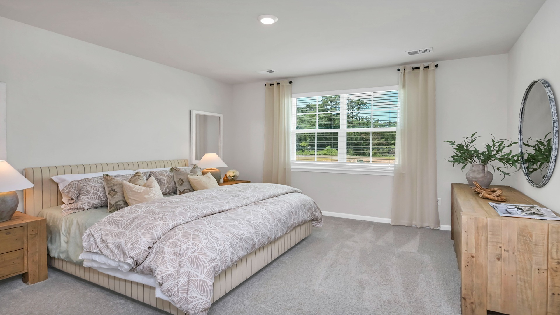 Primary bedroom with large window facing the backyard