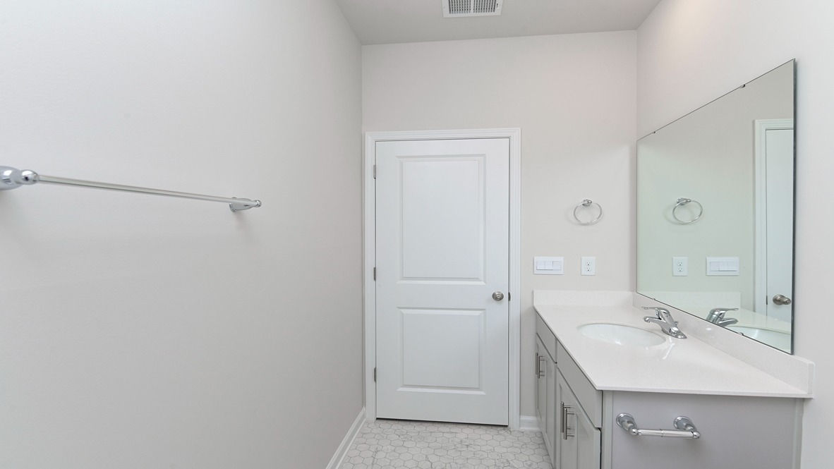 Gray cabinetry and quartz countertops on vanity in bathroom 2