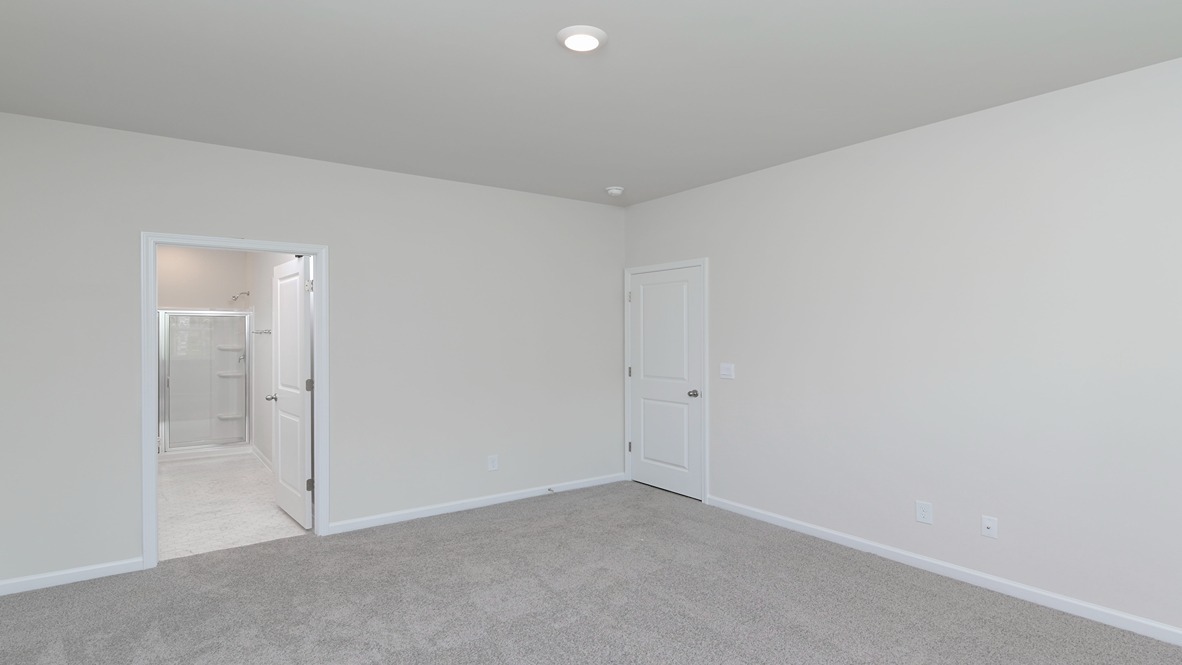 Primary bedroom in home for sale in Lexington with direct access to en-suite bathroom and walk-in closet
