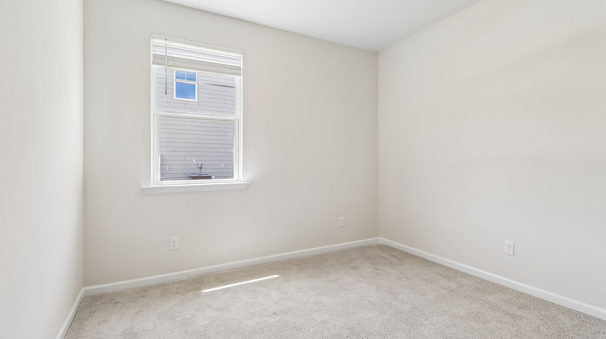 Bedroom 3 with window for light and carpet flooring