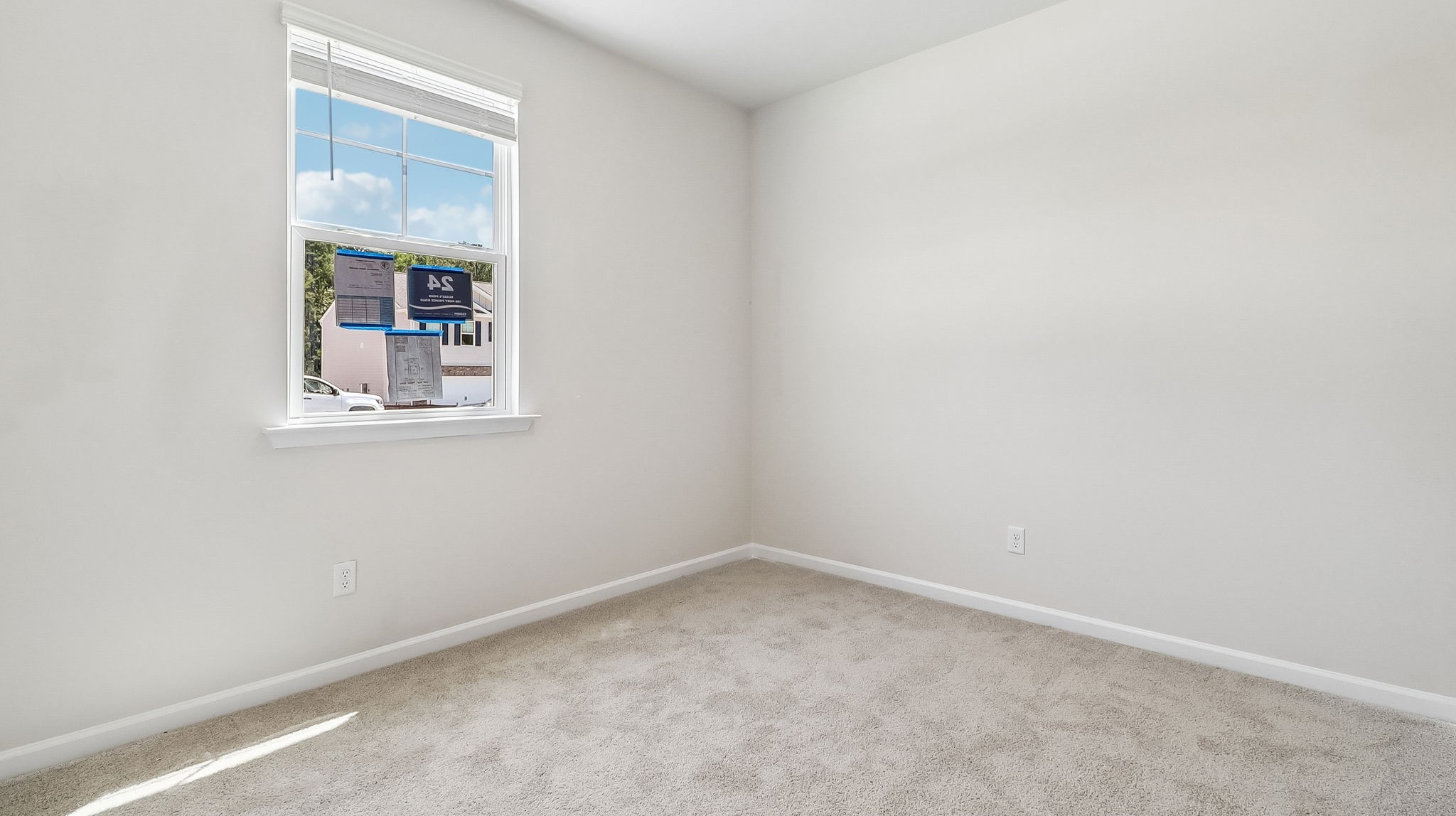 Front bedroom 2 with carpet flooring and a window for light