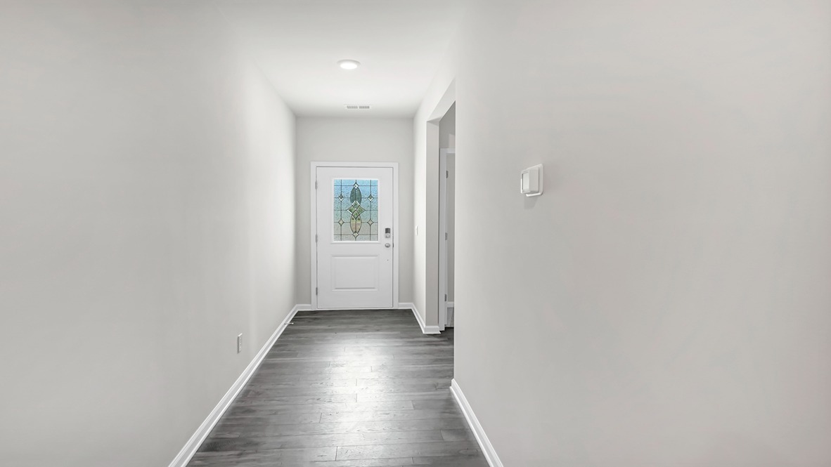 Front foyer of the home extends from the front door with glass insert for natural light