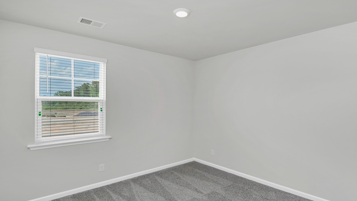 Bedroom 3 with window for light and carpet flooring