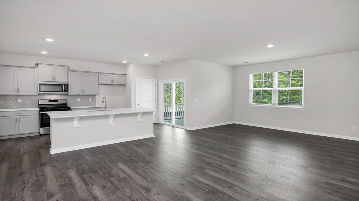 Open concept dining, living, and kitchen areas in ranch-style home for sale in Sease's Pond