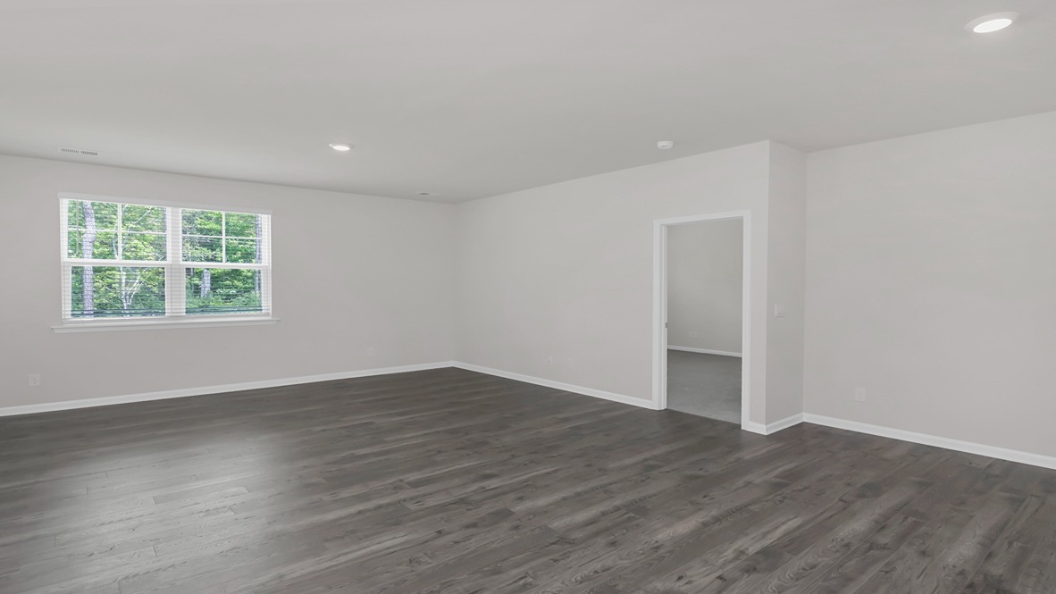 Access to primary suite from living area at the back of the home