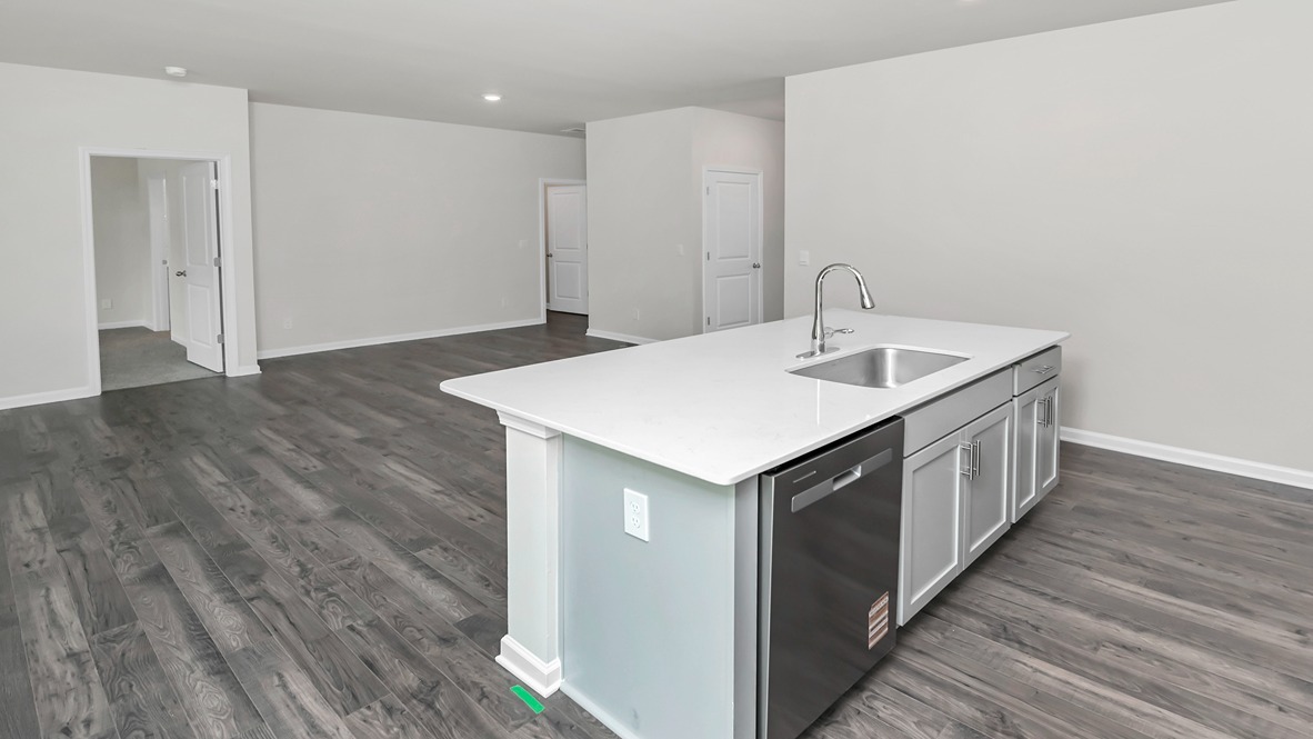 Floating kitchen island overlooks the open dining and living spaces