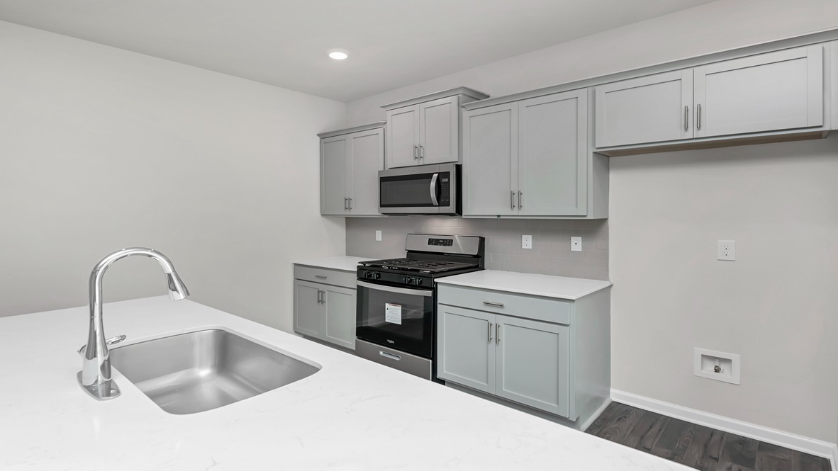 Kerry kitchen with gray cabinetry and white quartz countertops