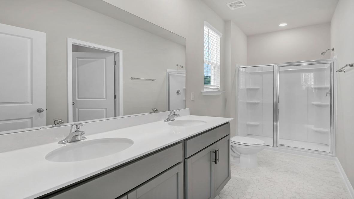 Standup primary shower with glass front in the Kerry primary bathroom