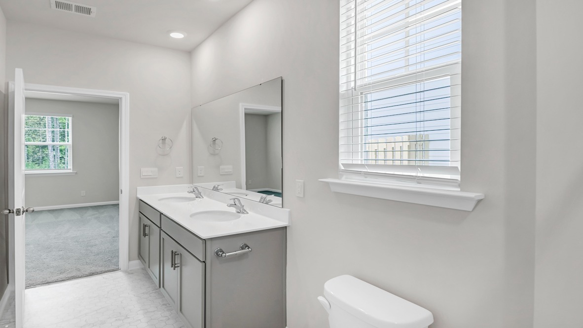 Double primary vanity with gray cabinets and white quartz countertops