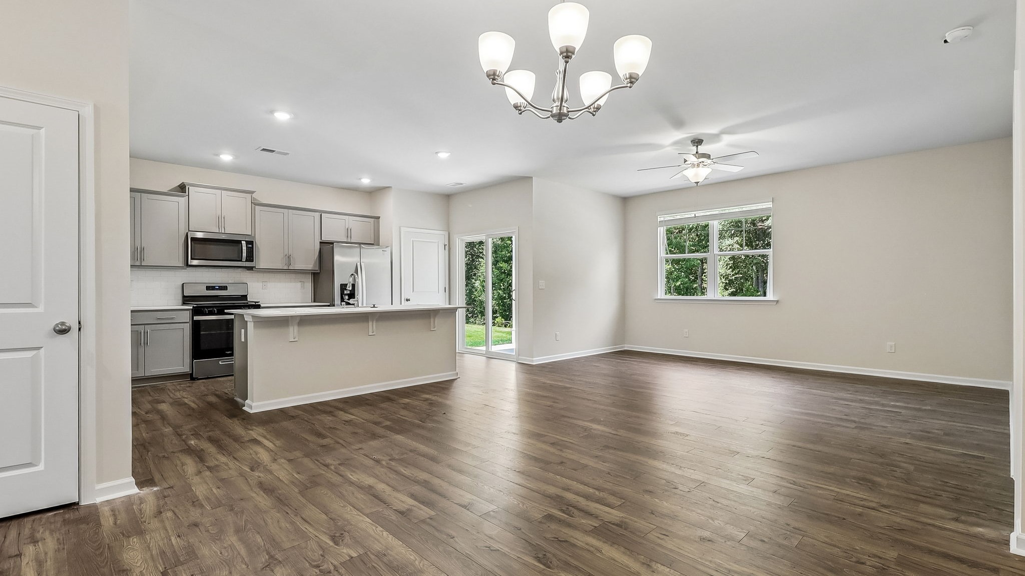 Open concept dining, living, and kitchen areas in ranch-style home for sale in Sease's Pond