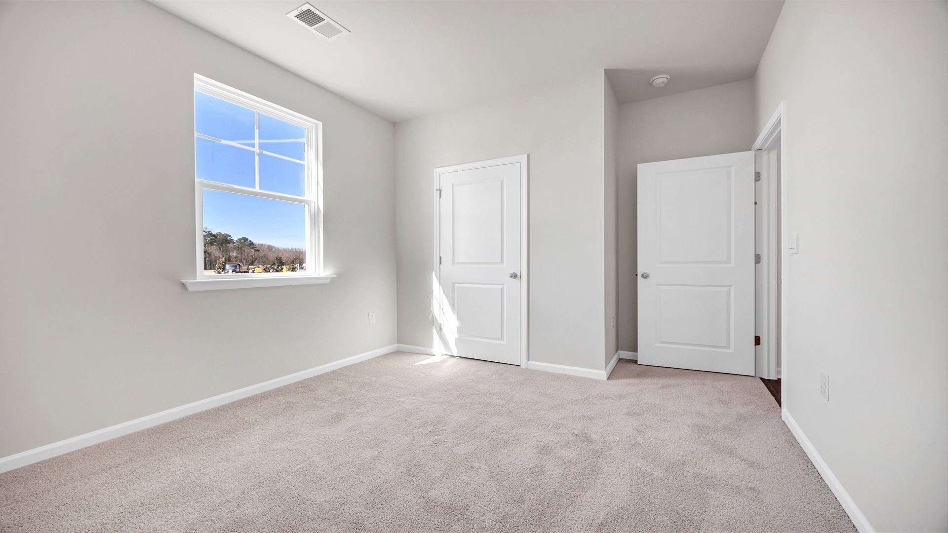 Front bedroom 2 with front facing window and private closet