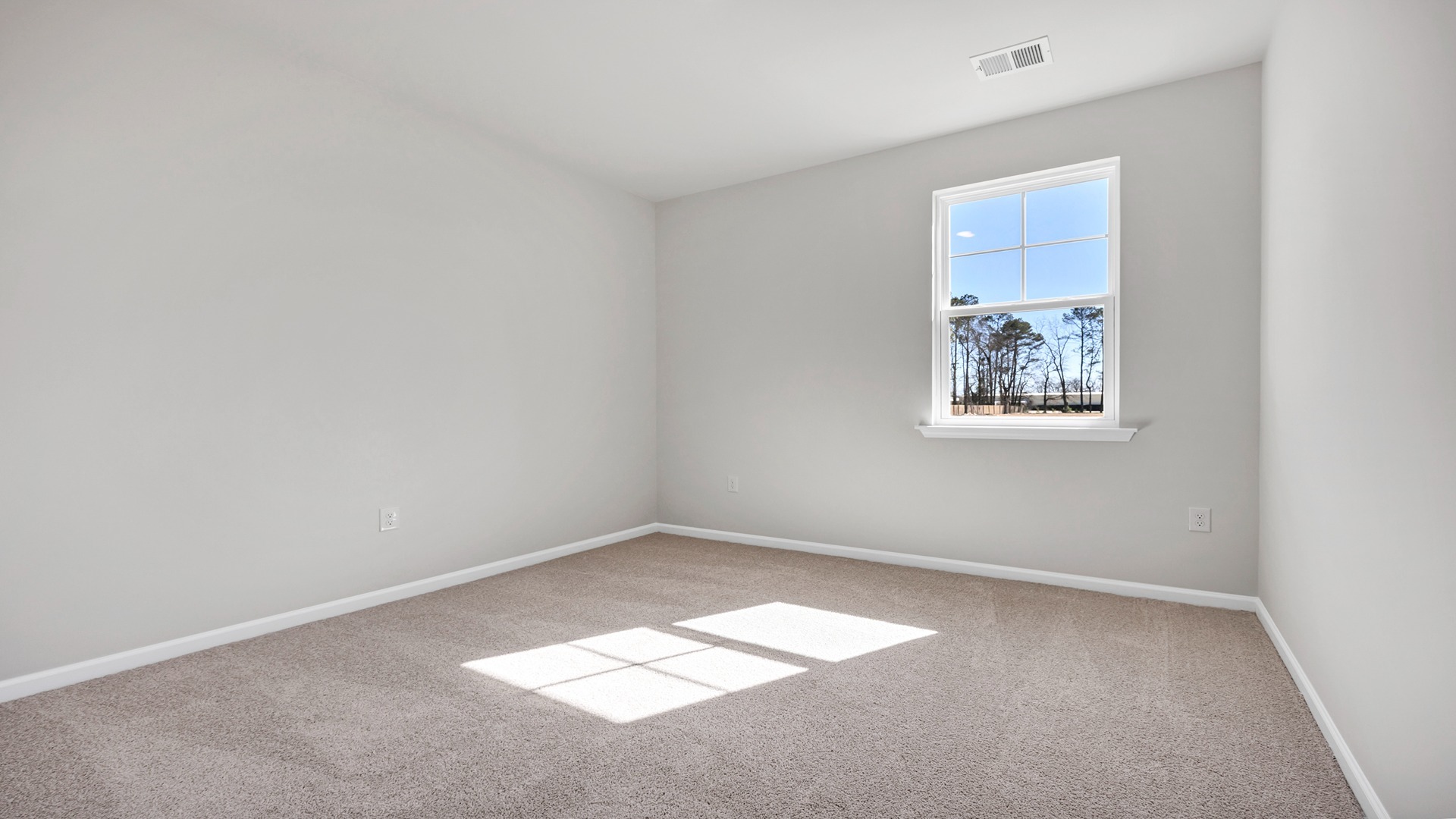 Bedroom 3 with a window for light and carpet floors