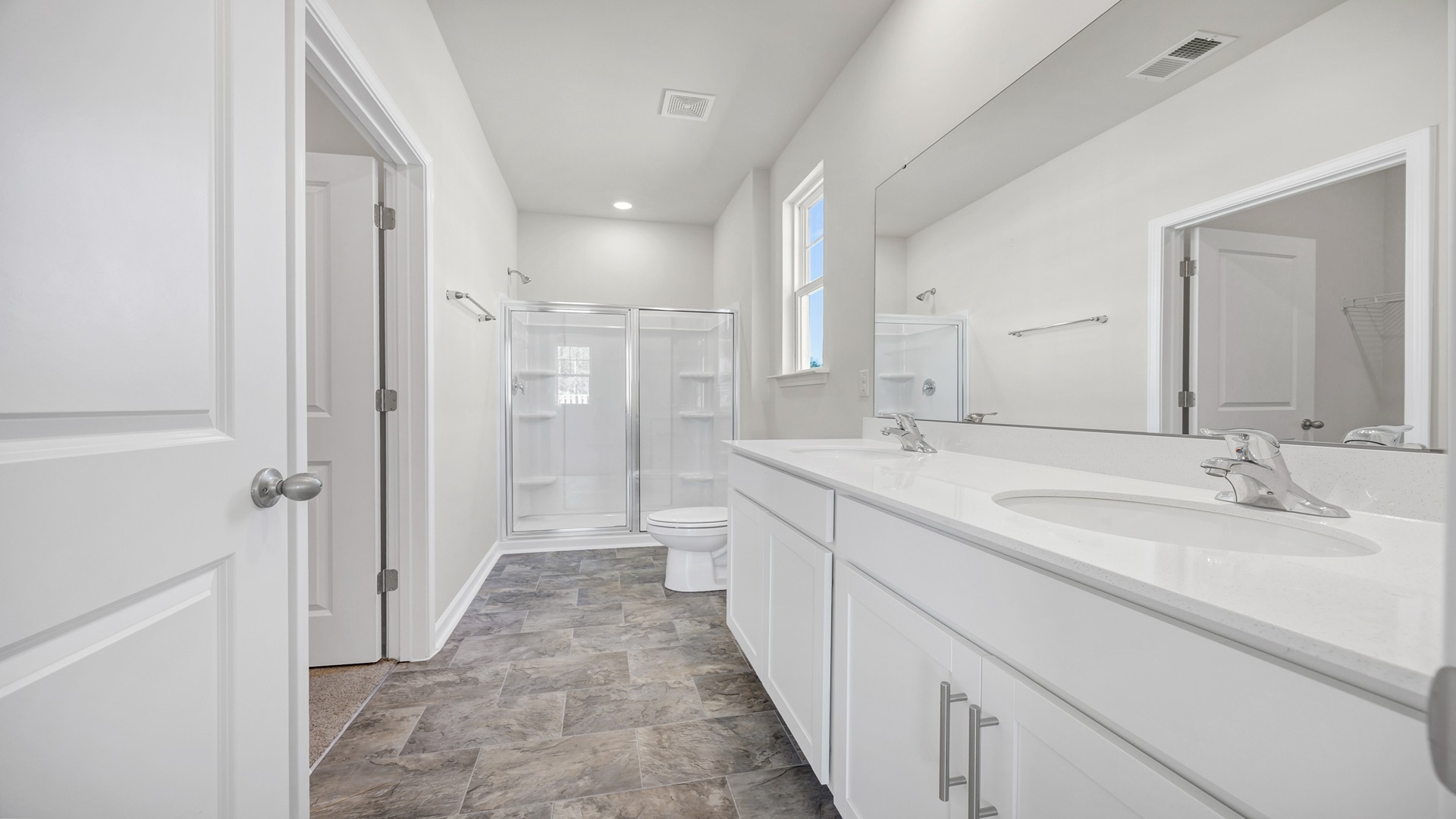 Standup primary shower and double vanity in bathroom