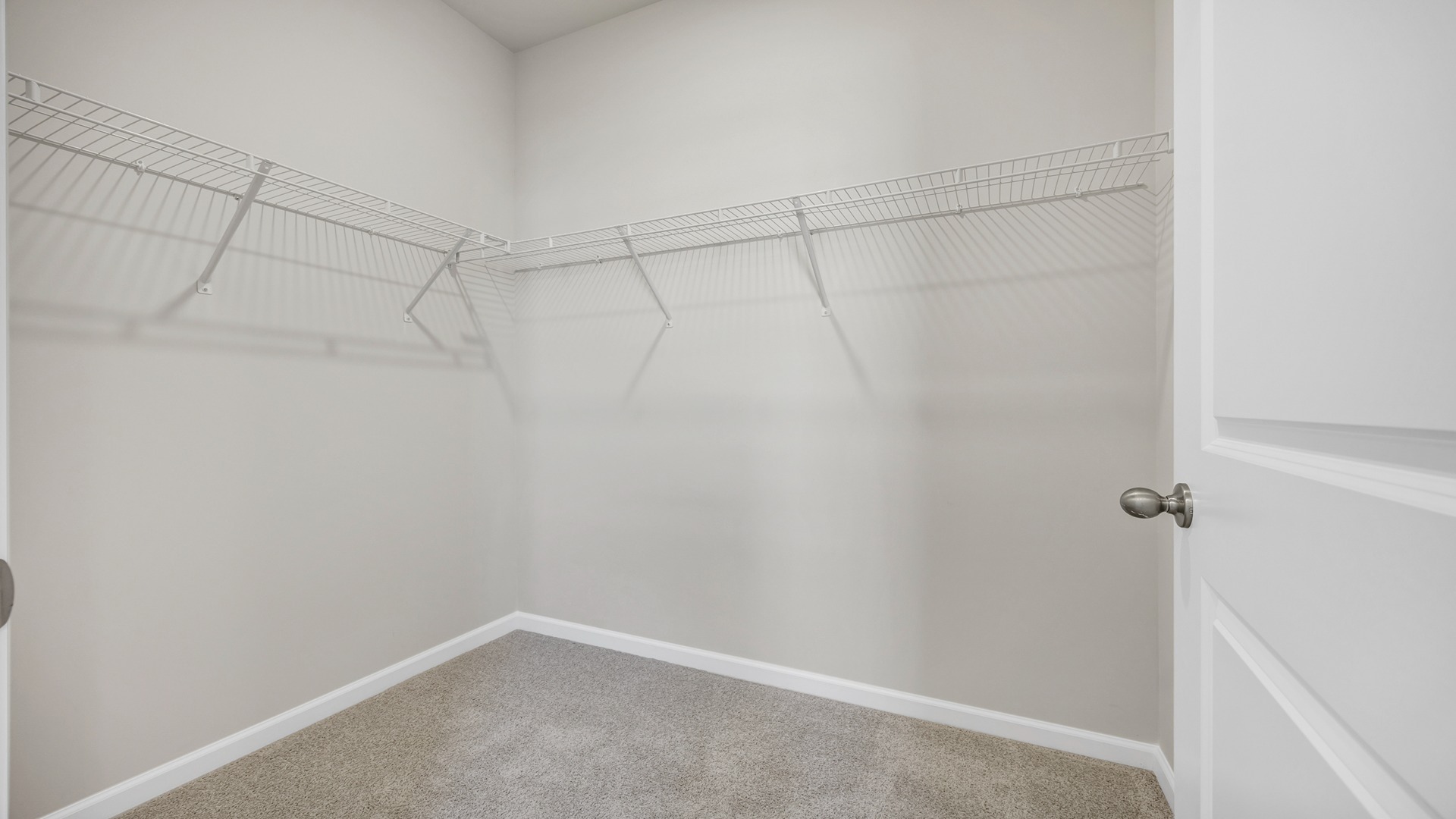 Walk-in primary closet in the primary bathroom