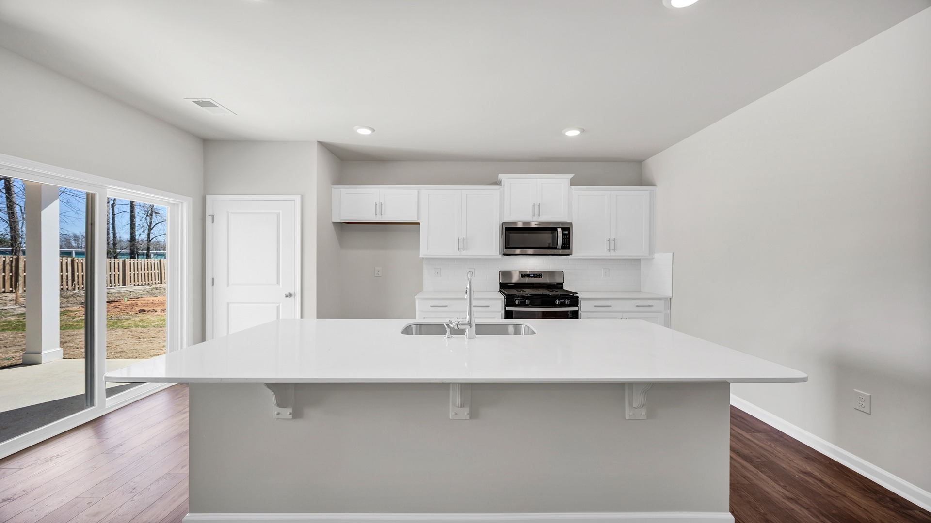 New construction kitchen with white quartz countertops and white cabinets