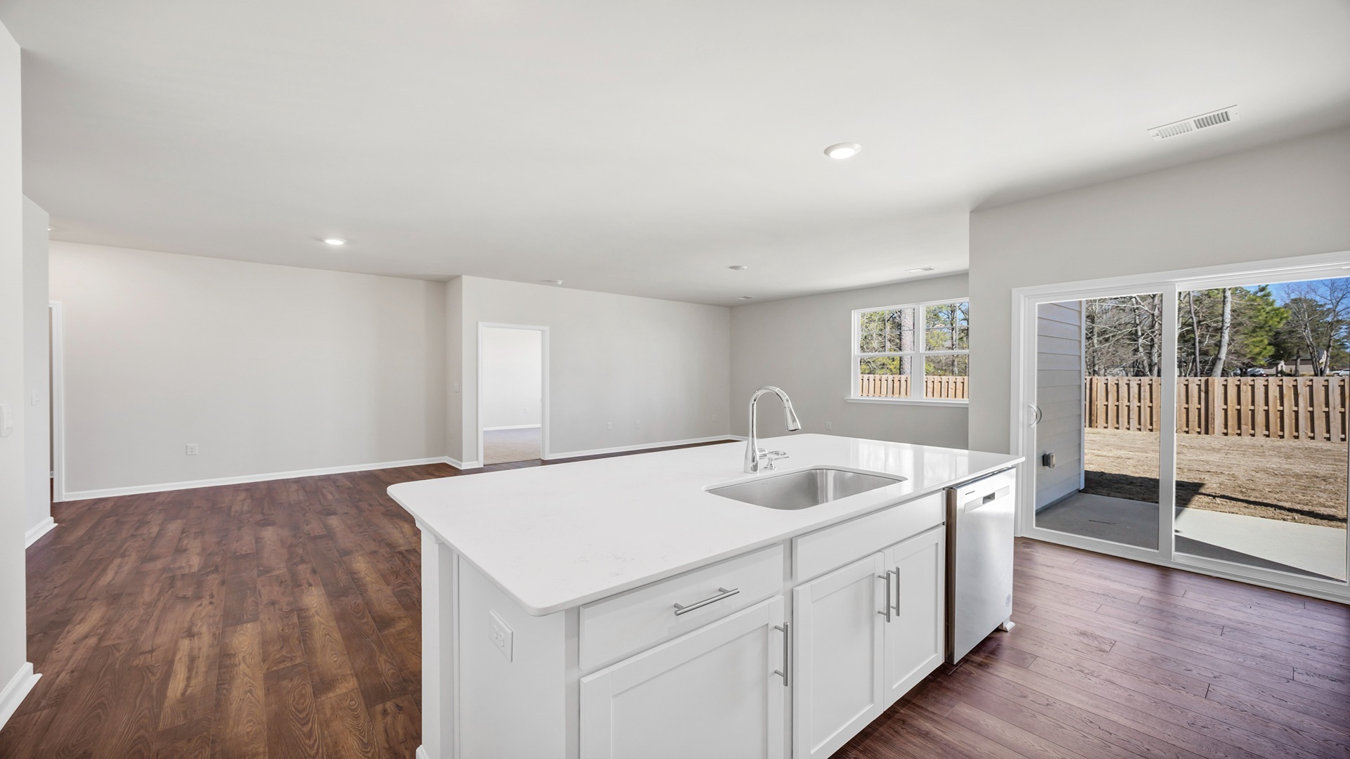 Floating kitchen island overlooks the open dining and living areas