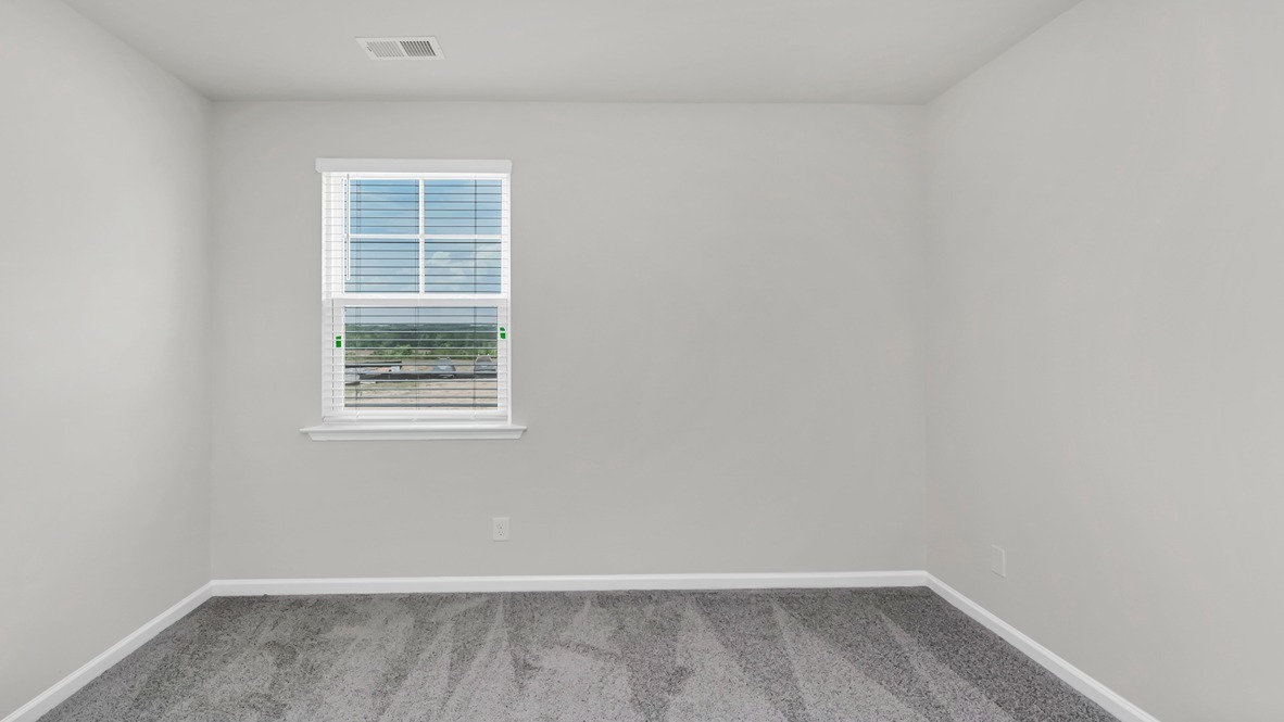 Bedroom 3 with carpet flooring and a window for light