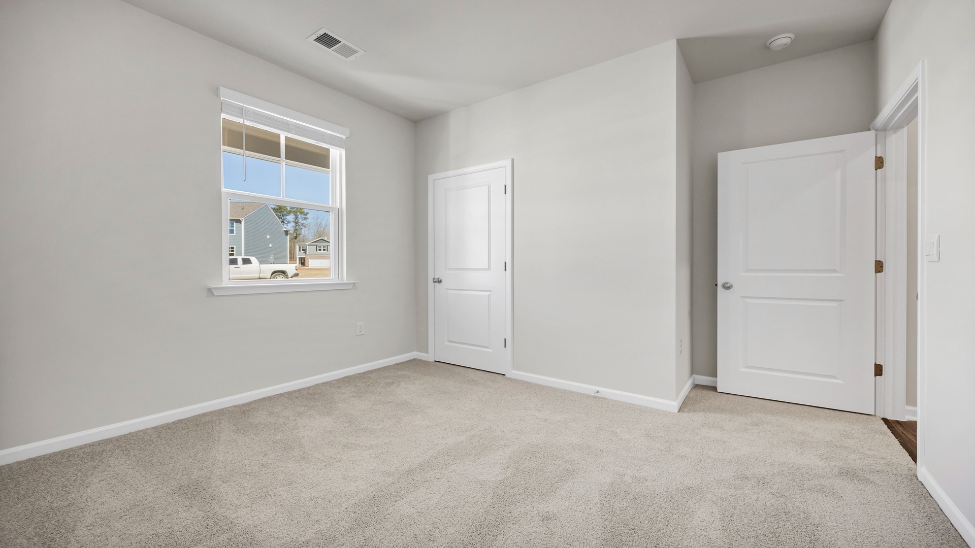 Bedroom 2 with front facing window and carpet flooring