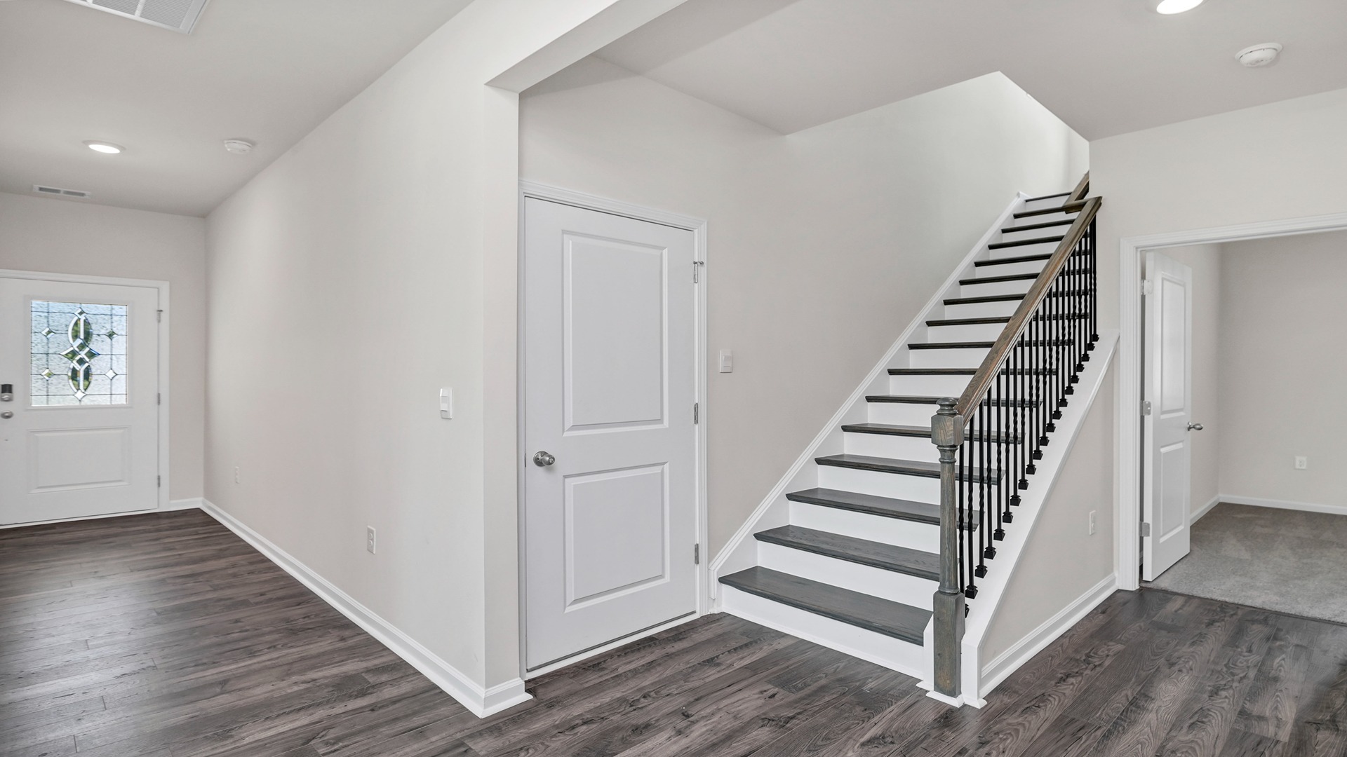 Stairway to upstairs off front foyer