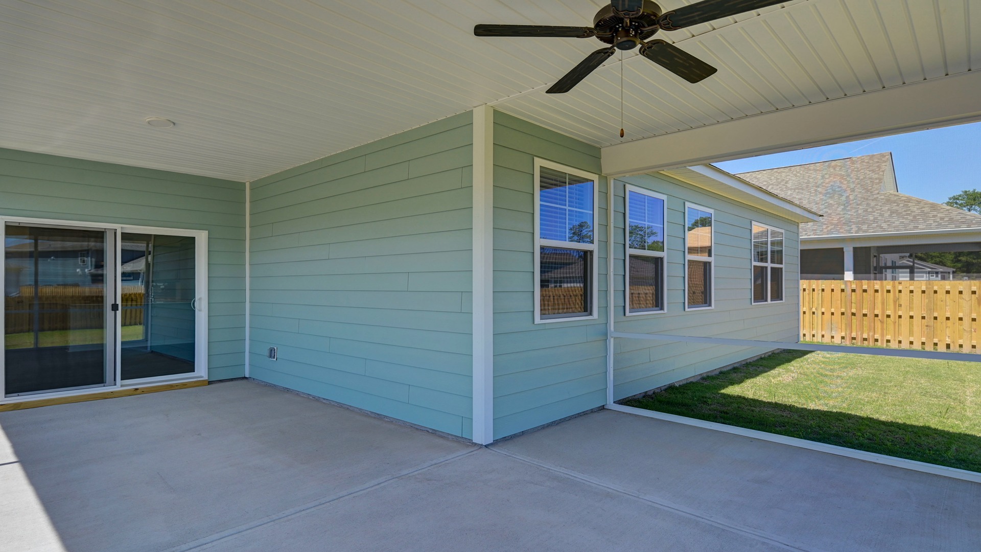 Extended, covered back patio of the Allex with a ceiling fan