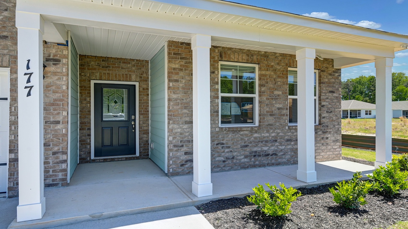 Covered front porch and partial brick siding on home for sale in Lexington County