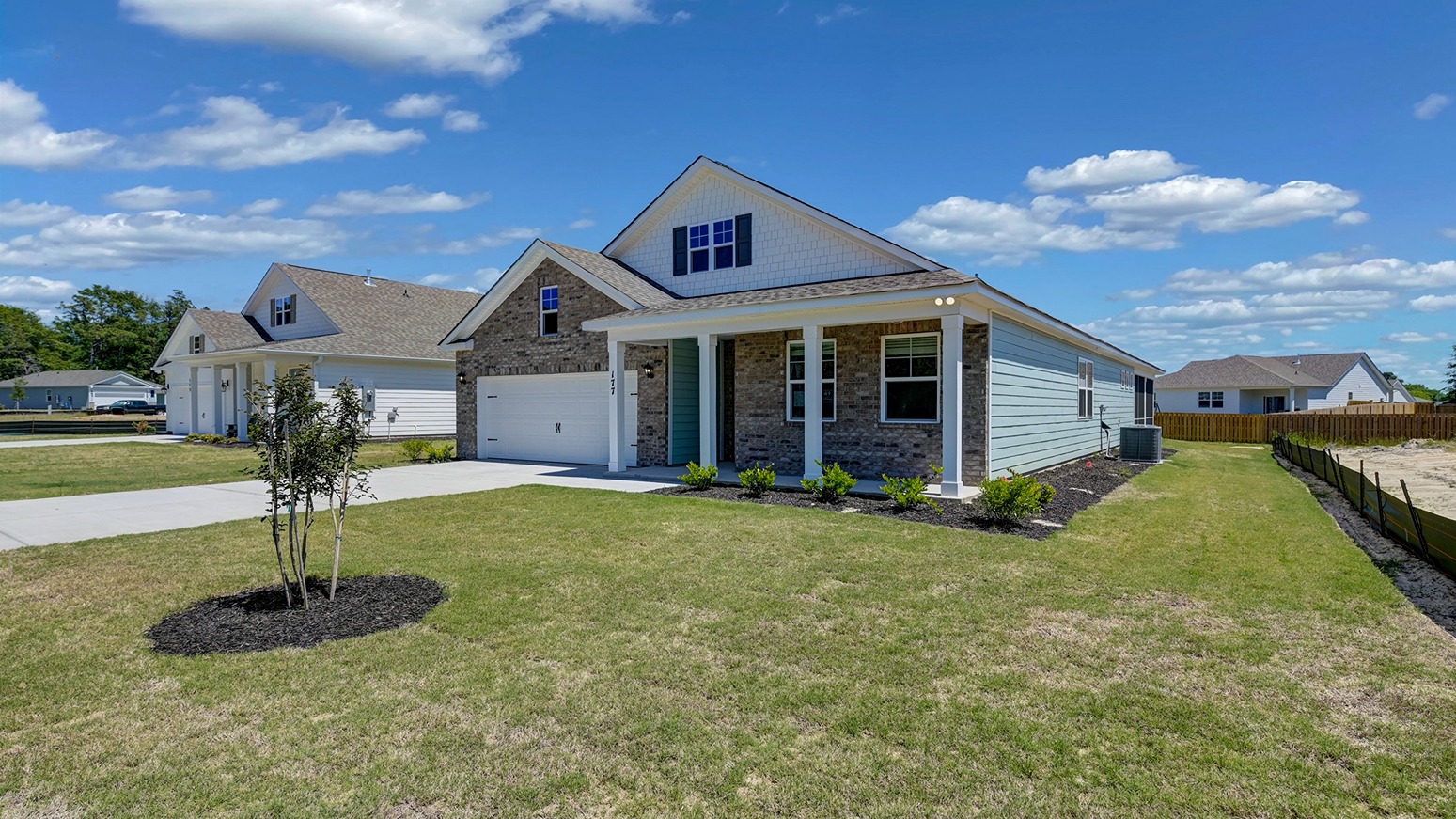 Front of home with covered front porch and a long driveway