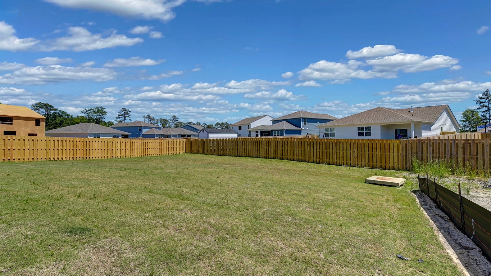 Backyard with green sod and privacy from neighboring fences