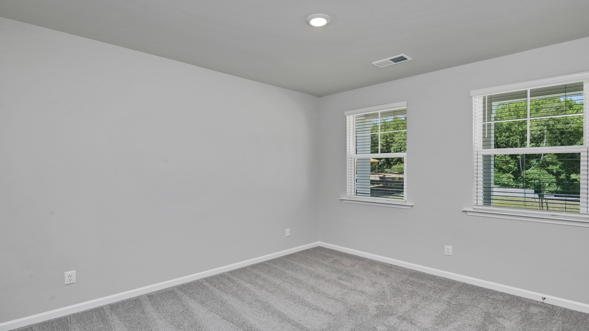 Front bedroom 2 with large, front-facing windows for light