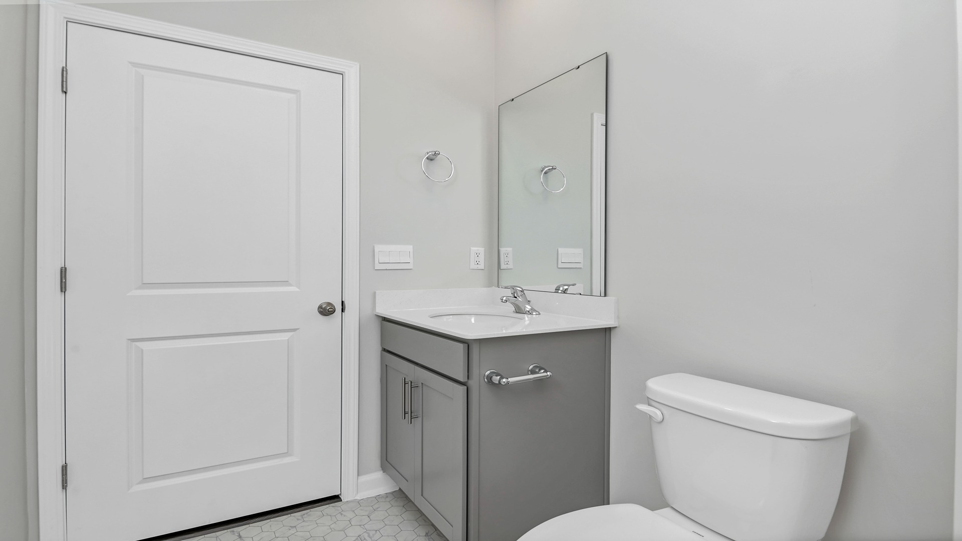 Bathroom 2 with gray cabinetry under the sink