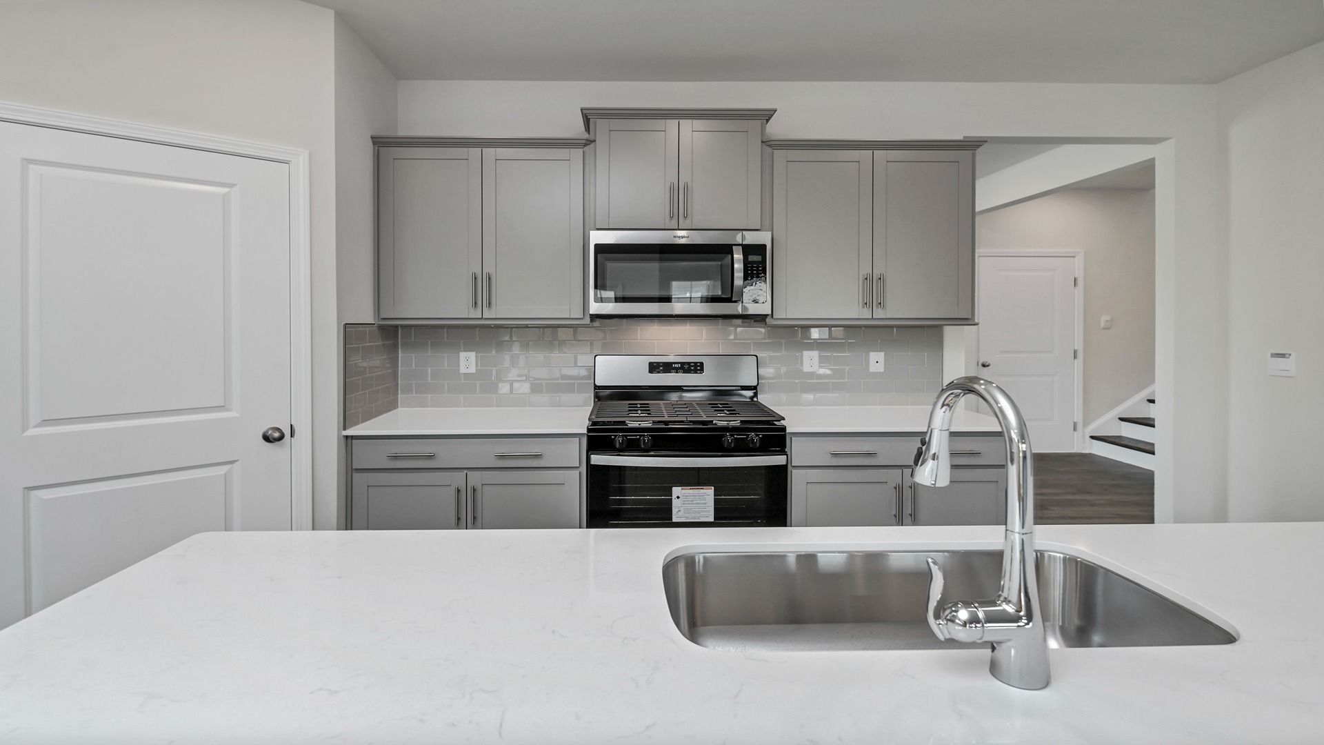 Stylish tile backsplash in kitchen and single basin sink