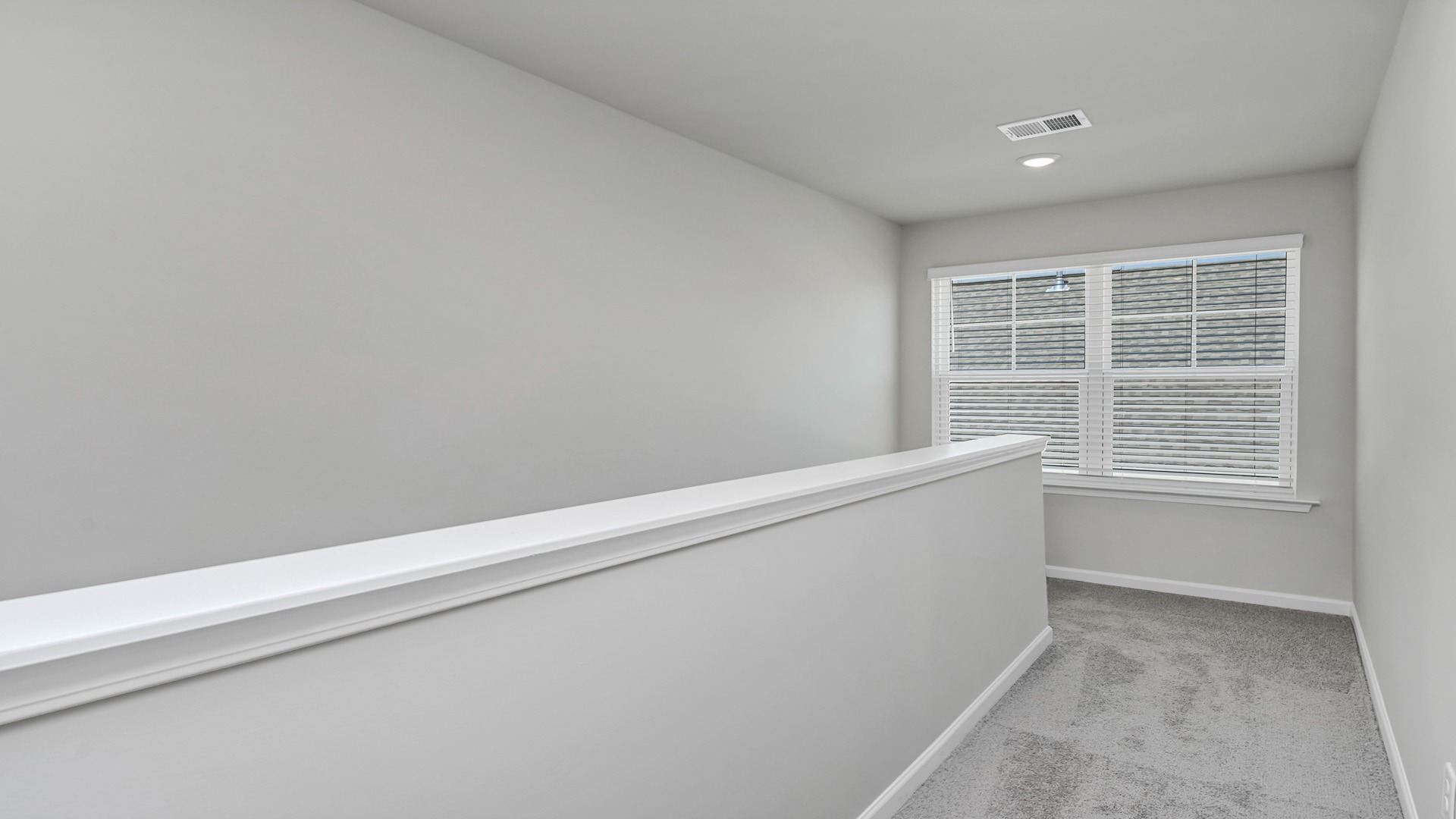 Upstairs stair landing with a large window for natural light upstairs