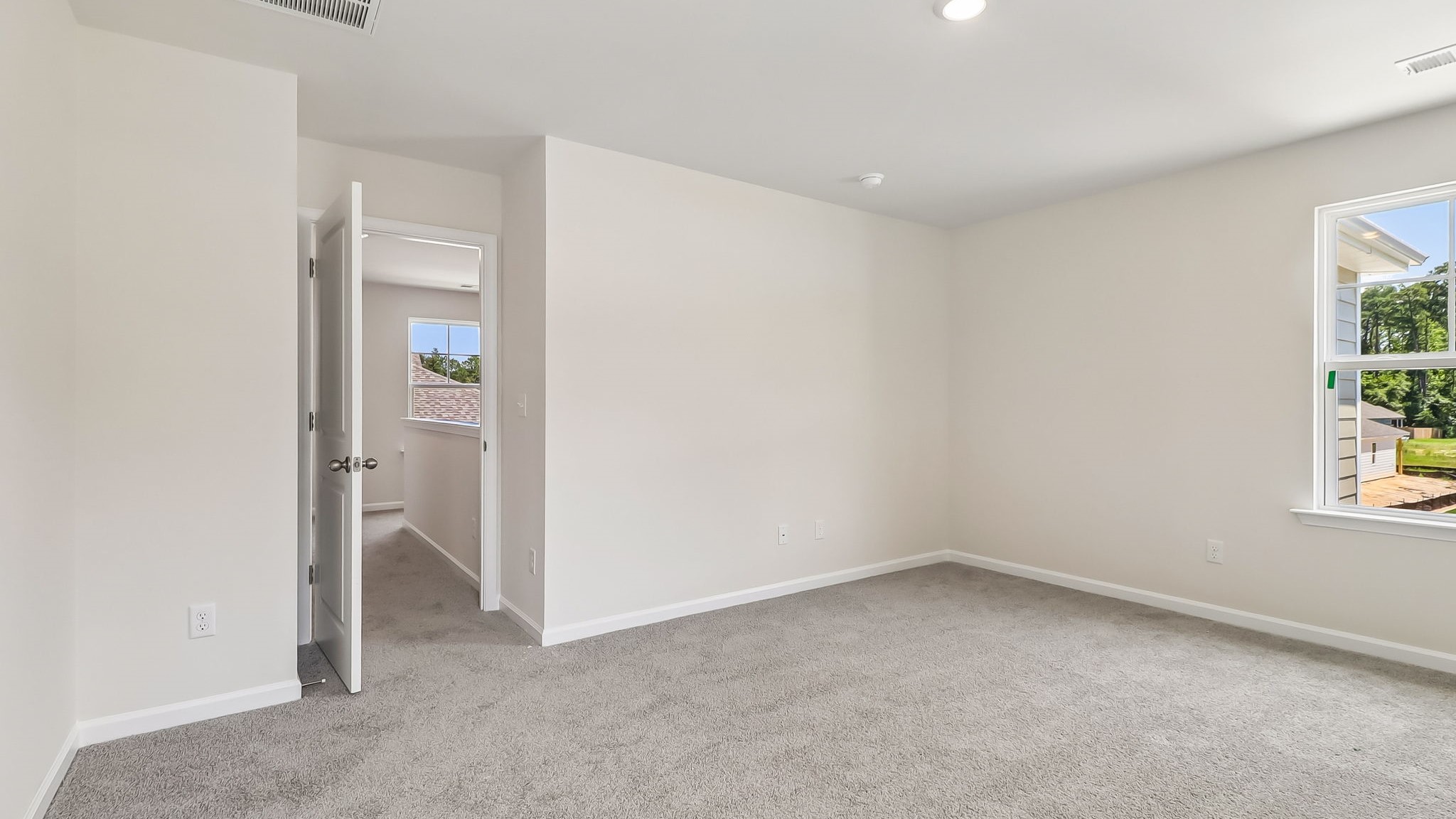 Carpet flooring and windows for light in primary suite