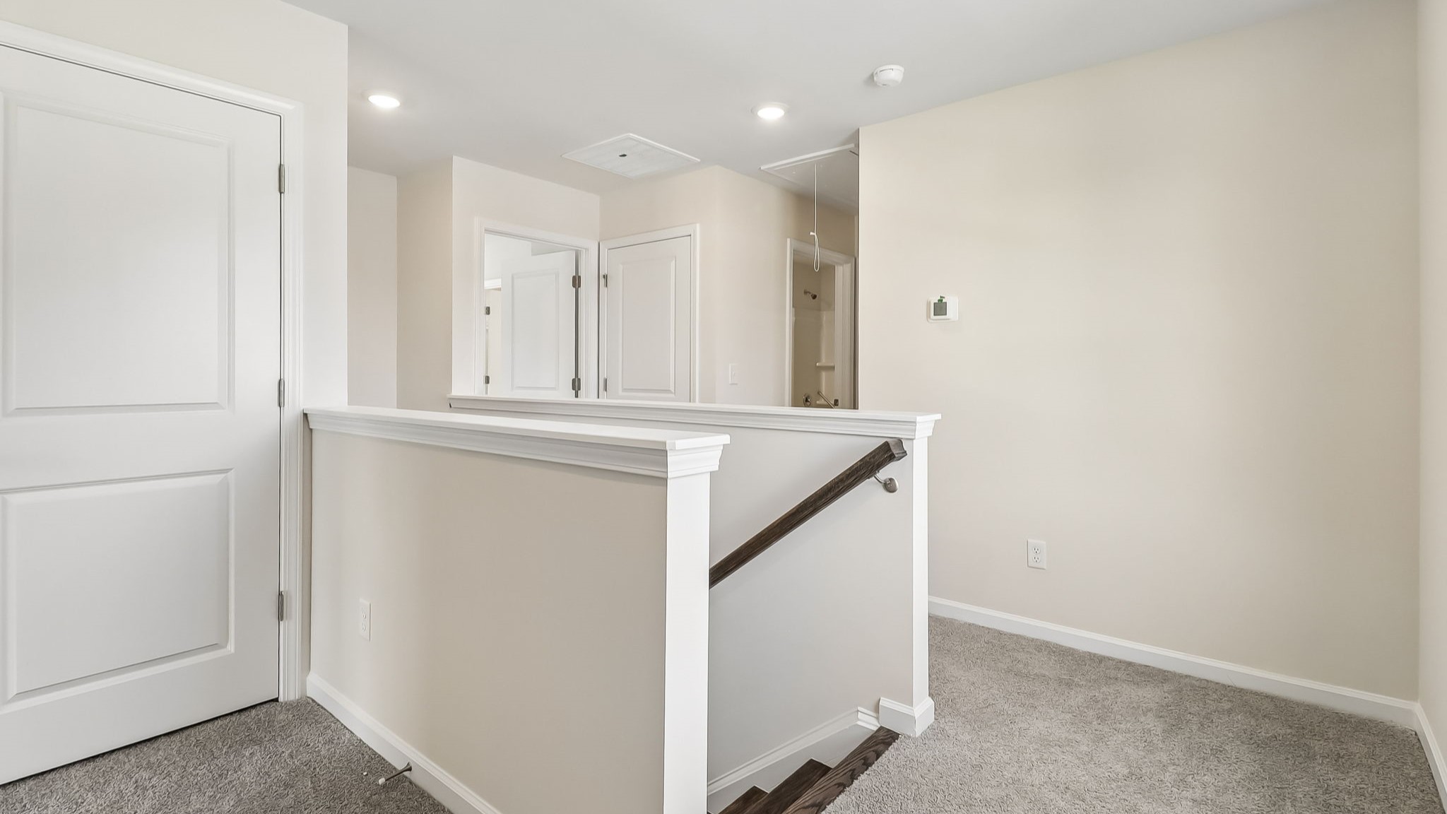 Upstairs stair landing from oak-tread stairway