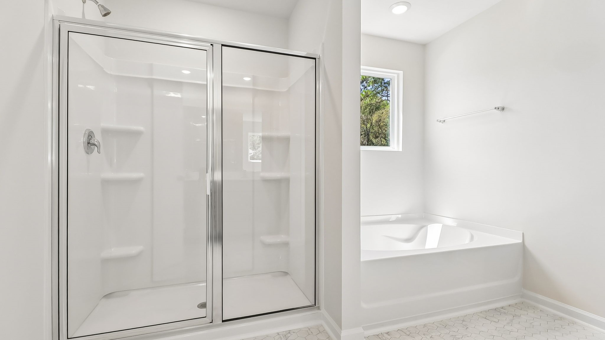 Walk-in primary shower and separate garden tub in primary bathroom