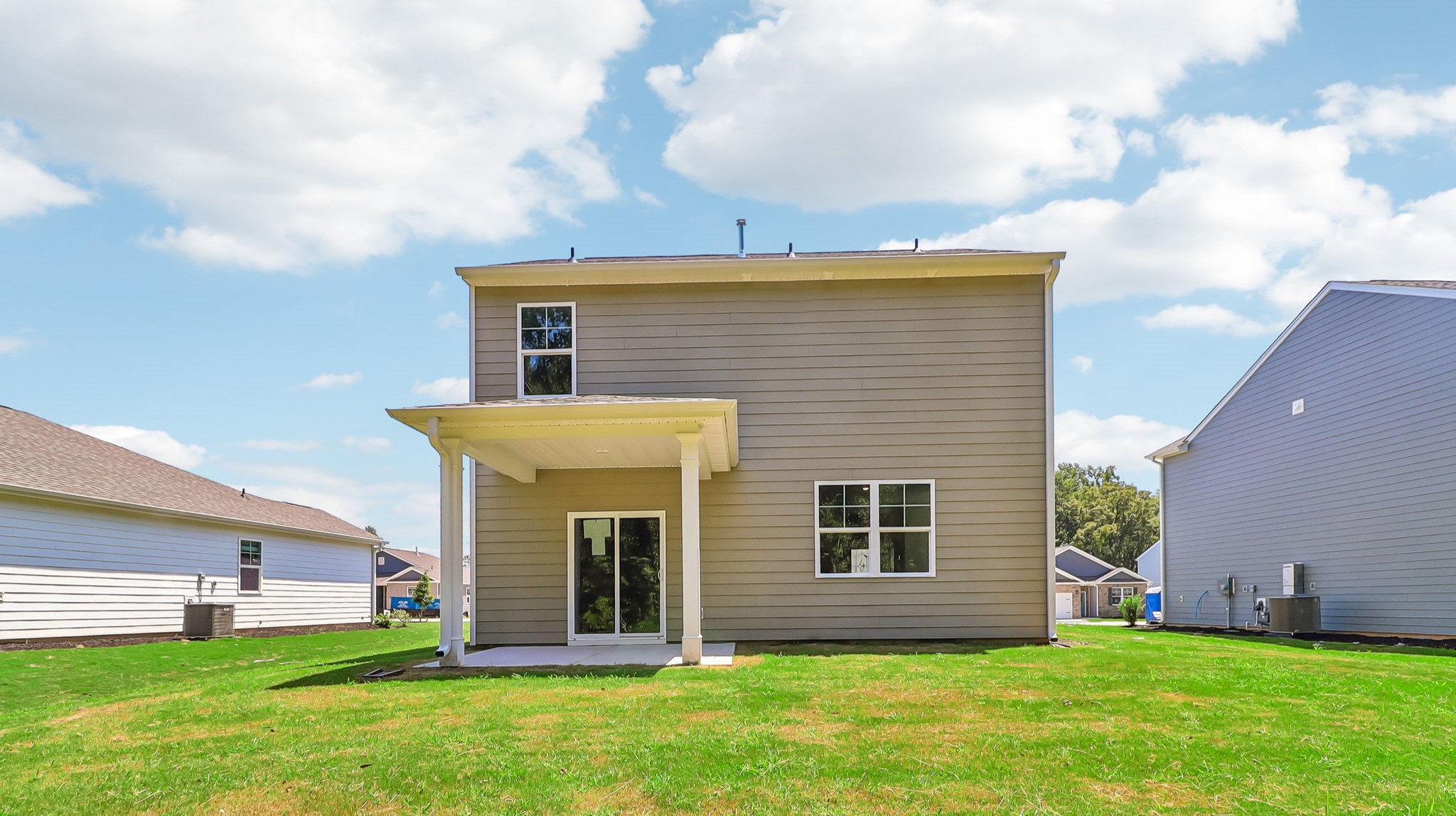 Back exterior of the home with tan Hardie Plank siding