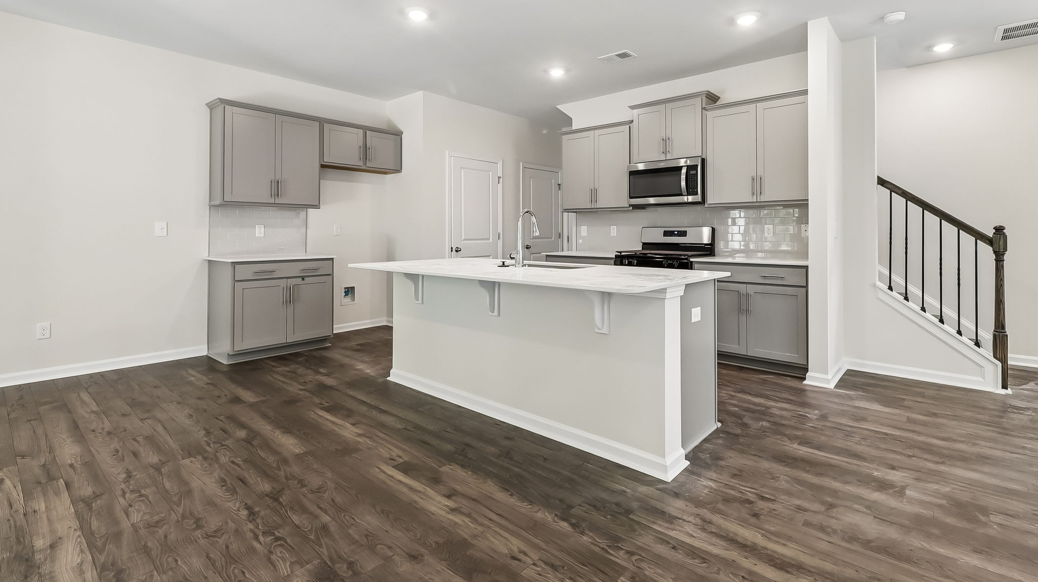 Tile backsplash and a spacious pantry finishes the kitchen space