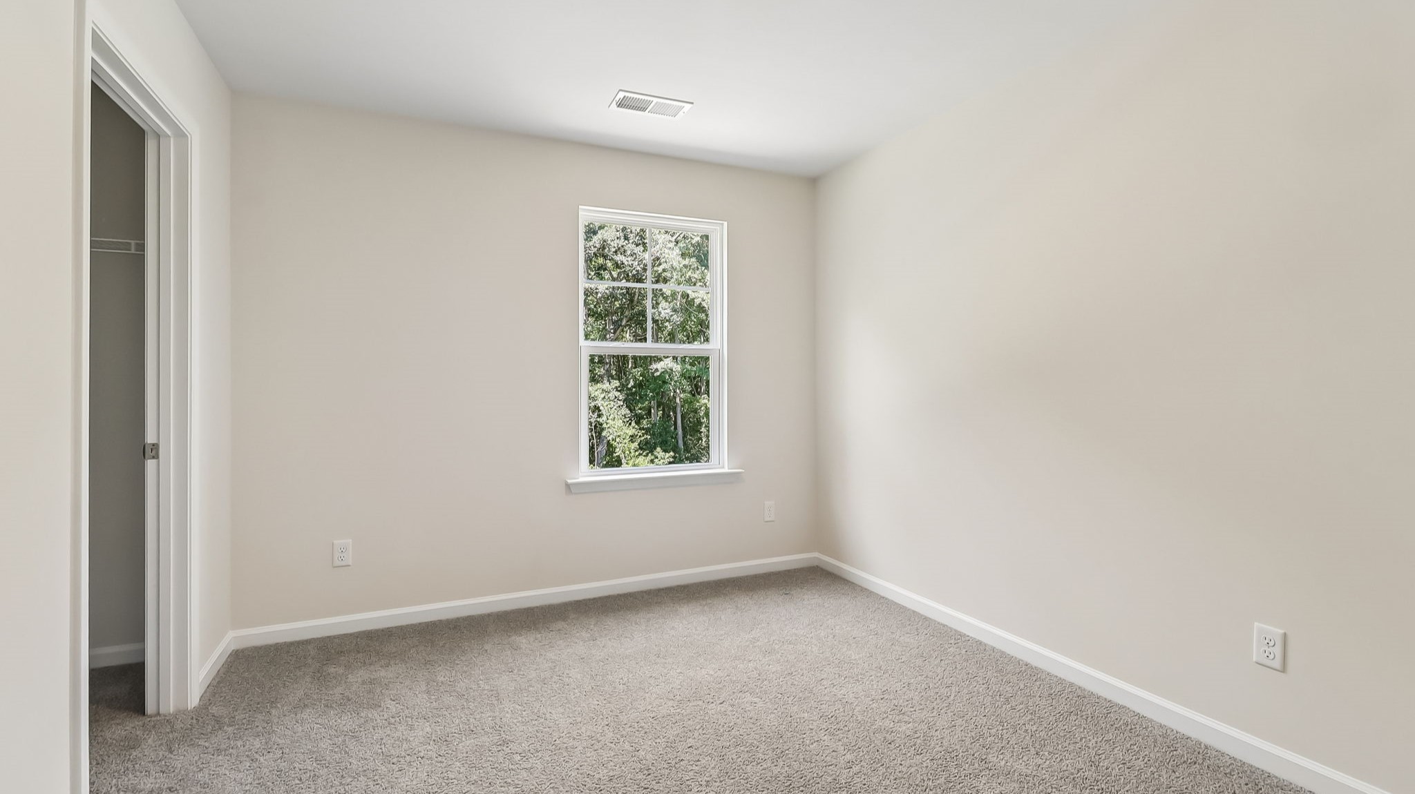 Bedroom 4 upstairs with a window for light and carpet flooring