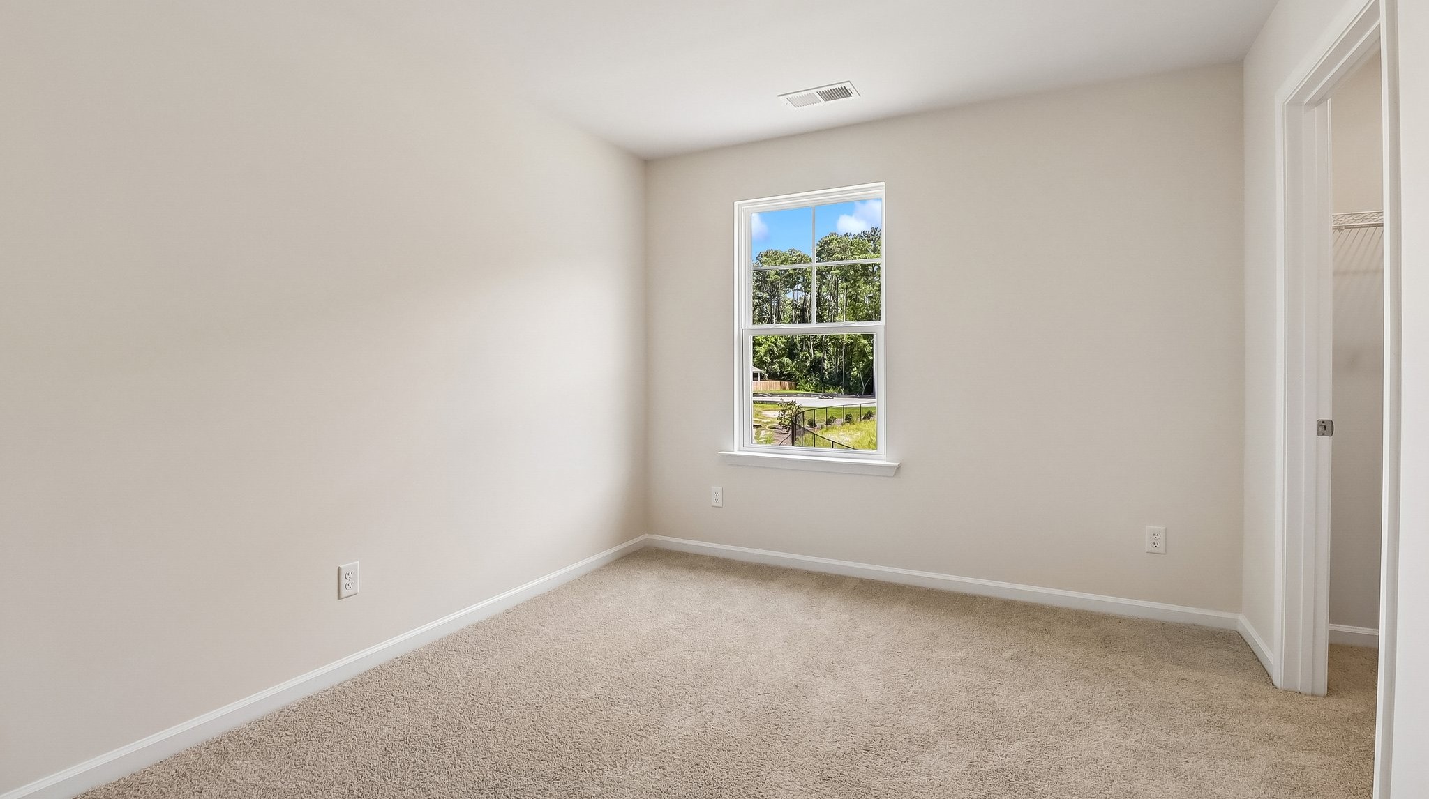 Bedroom 4 upstairs with carpet flooring and a window for light