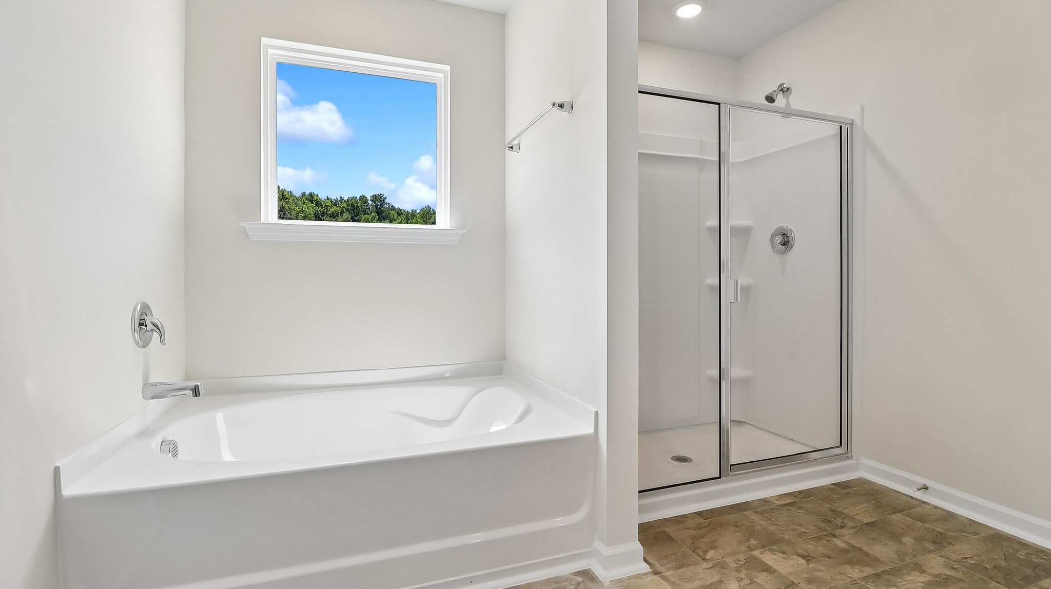 Bathtub and separate walk-in shower in primary bathroom