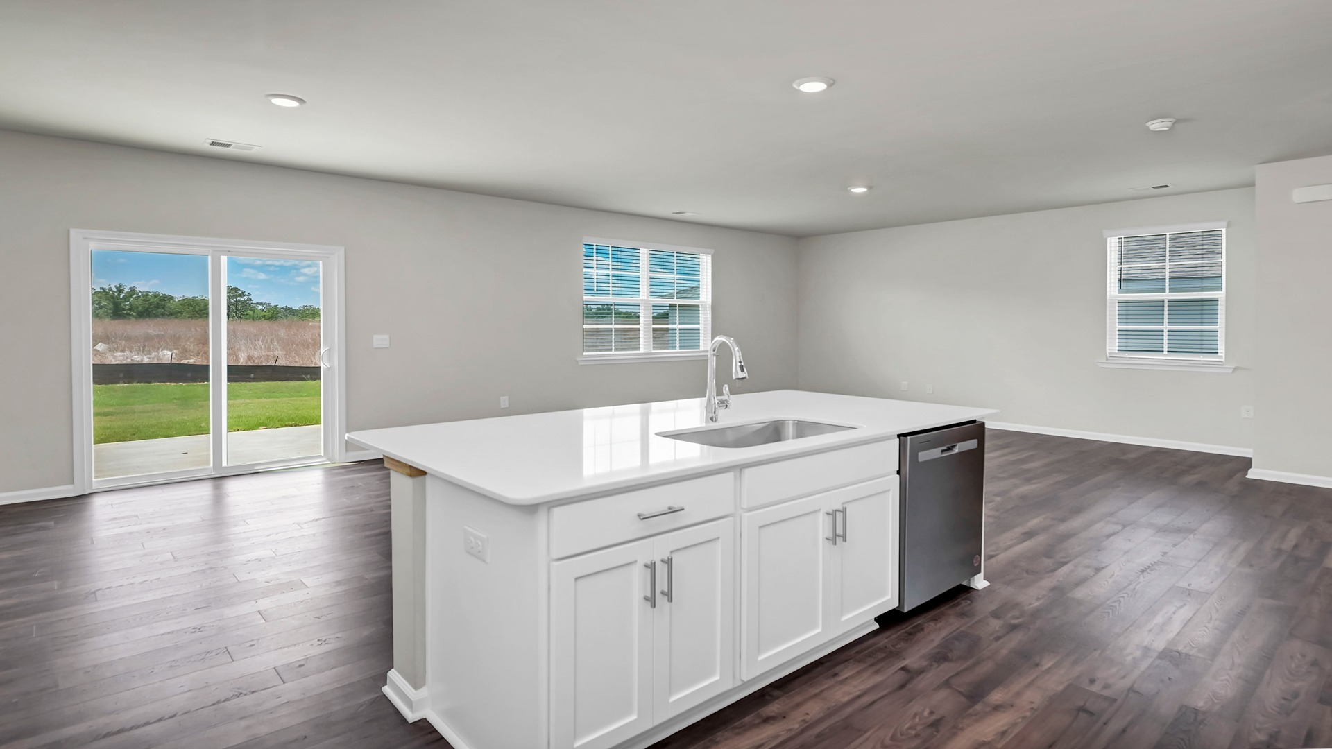 Floating kitchen island overlooks dining and living areas