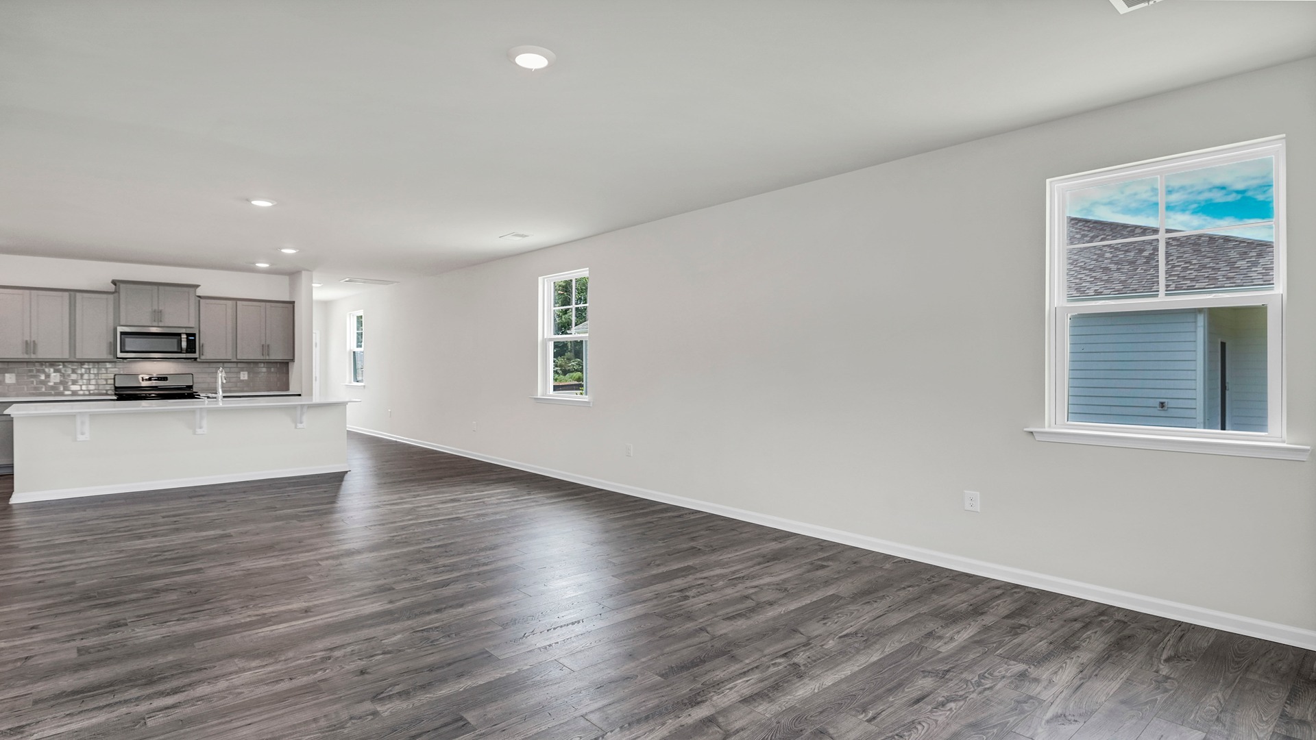 Open concept kitchen, dining, and living areas in the Manning floor plan for sale in Sease's Pond