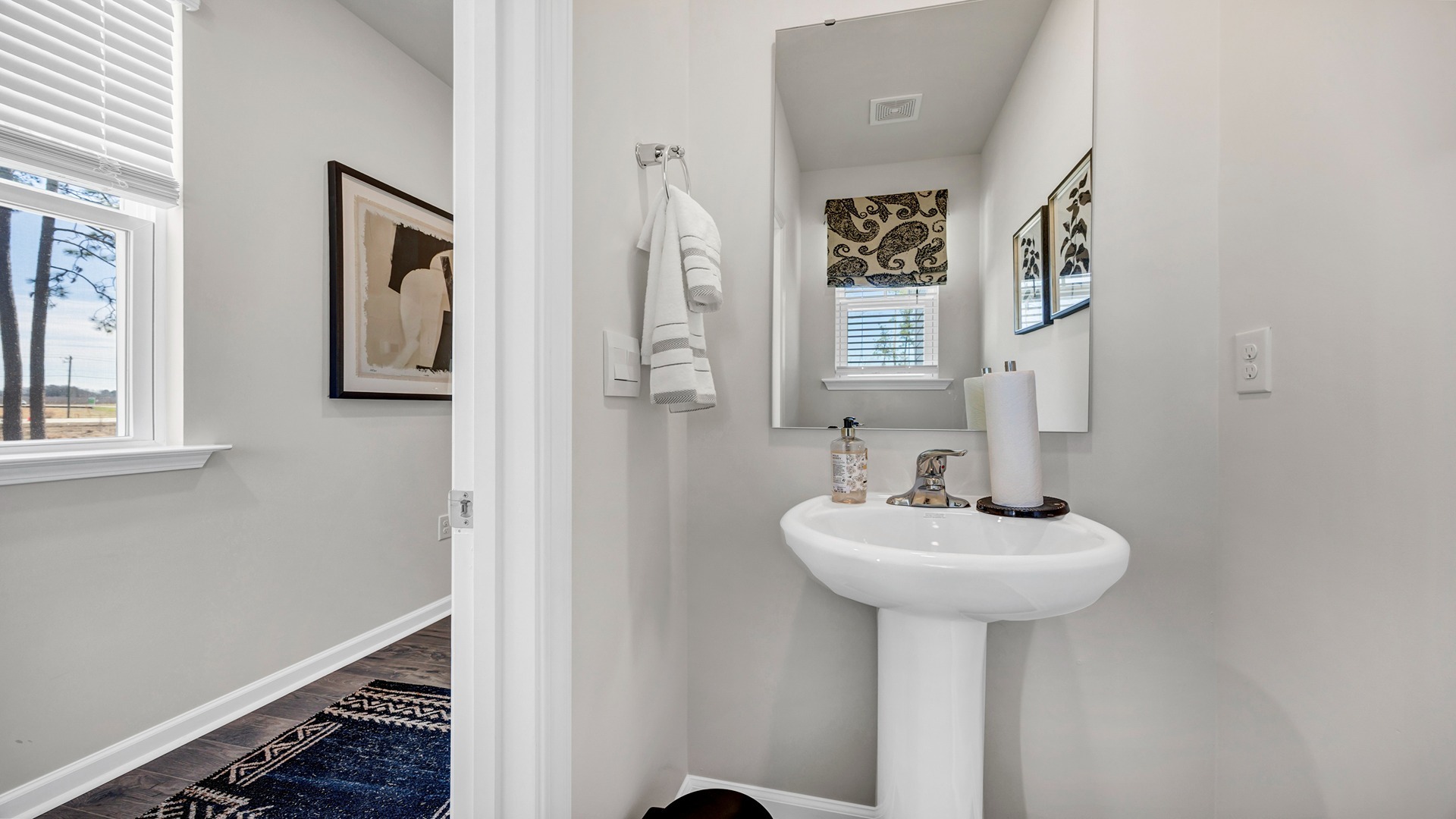 First-floor powder room off the front foyer near stairway to upstairs